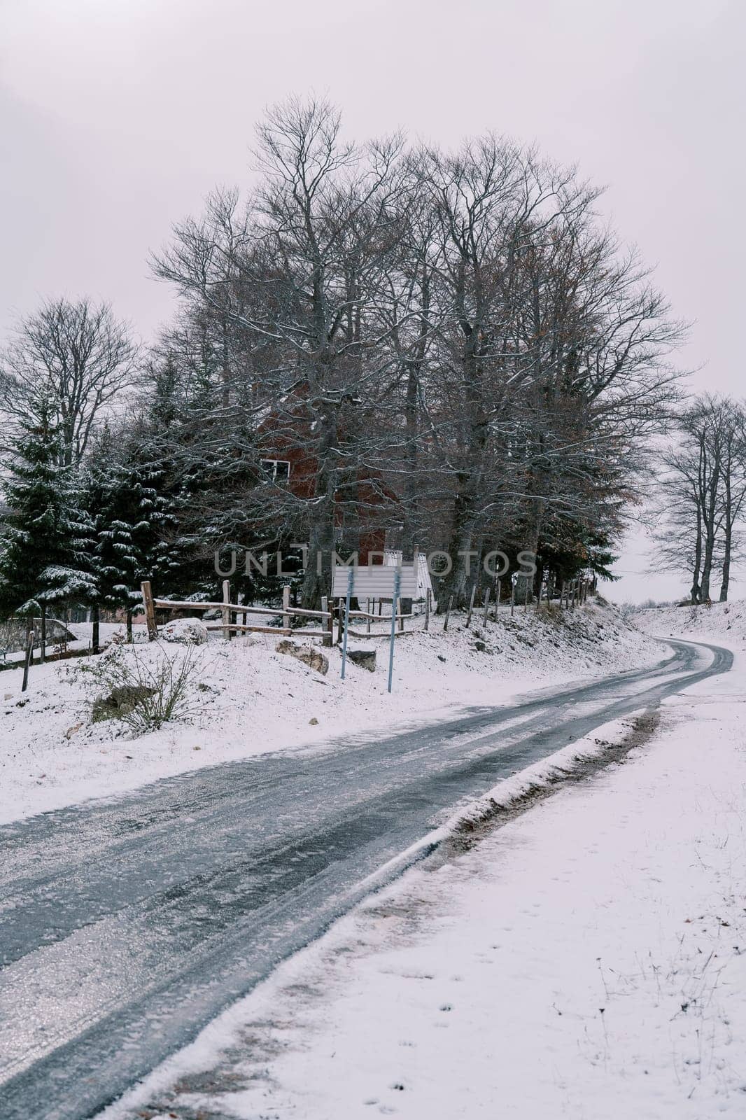 Icy road in a snowy village in the forest. High quality photo
