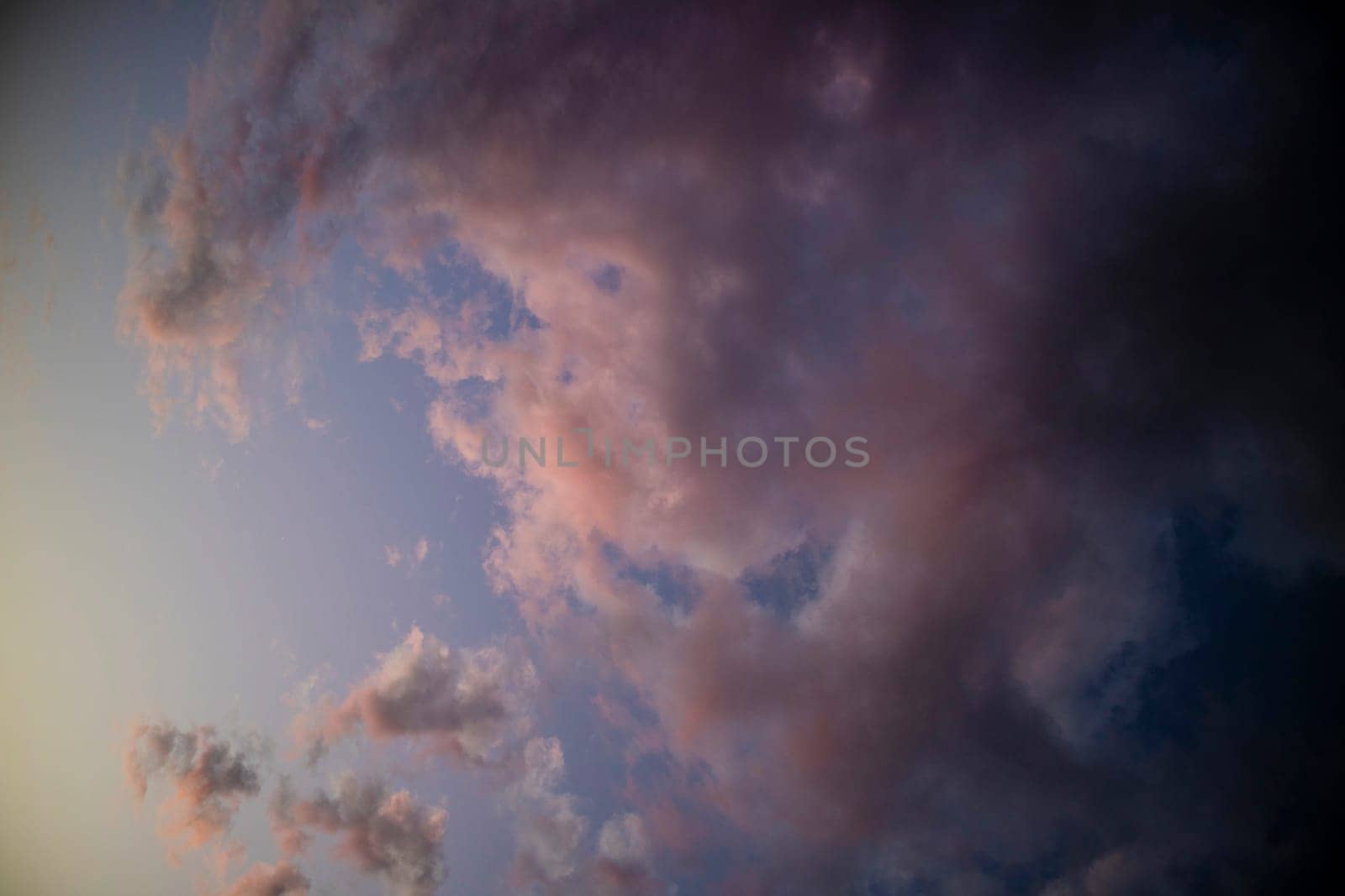 Photographic documentation of a group of colored clouds taken at sunset 