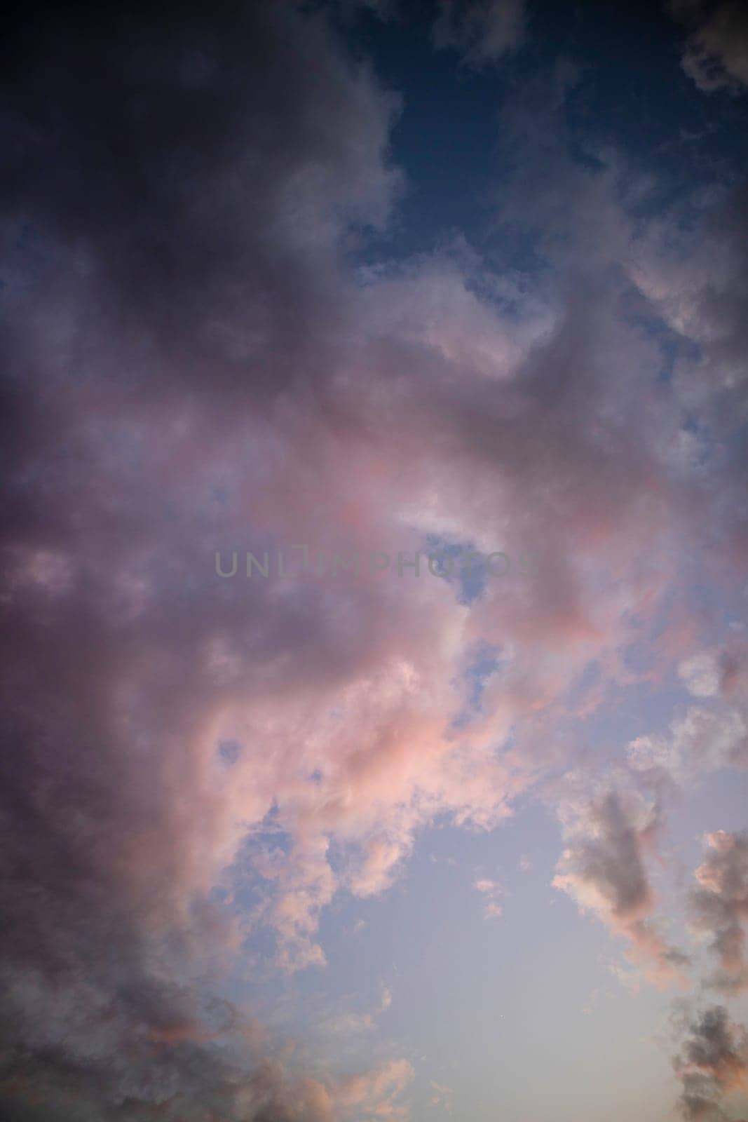 Photographic documentation of a group of colored clouds taken at sunset 