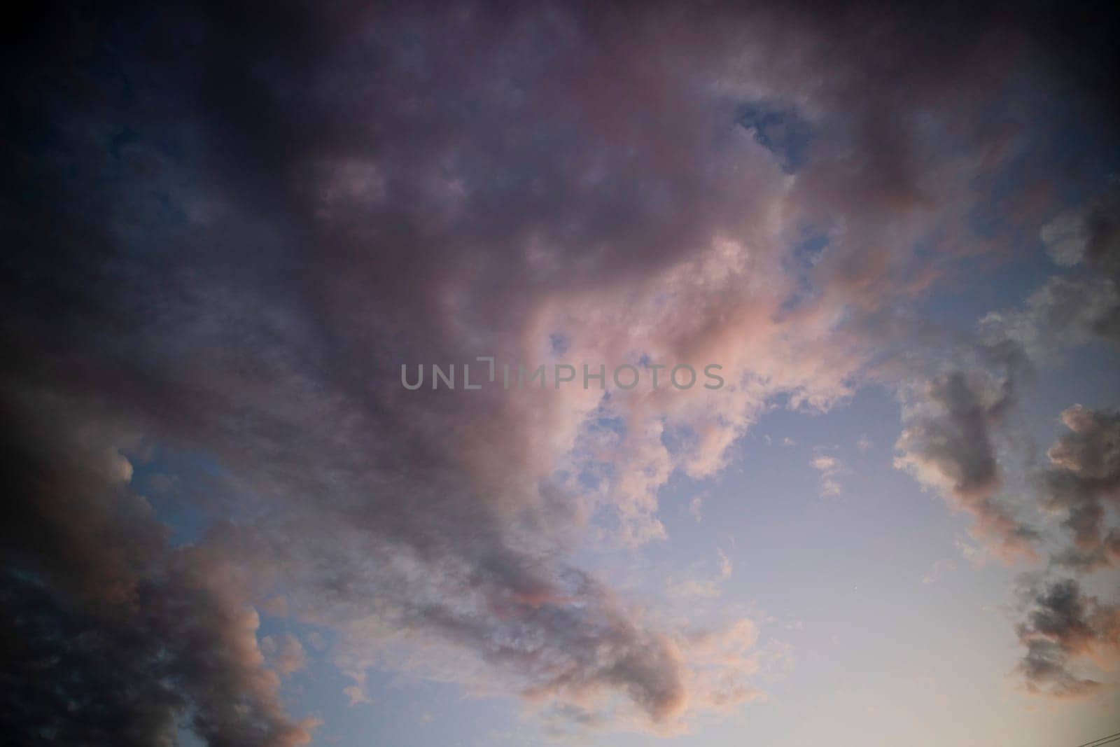 Photographic documentation of a group of colored clouds taken at sunset 