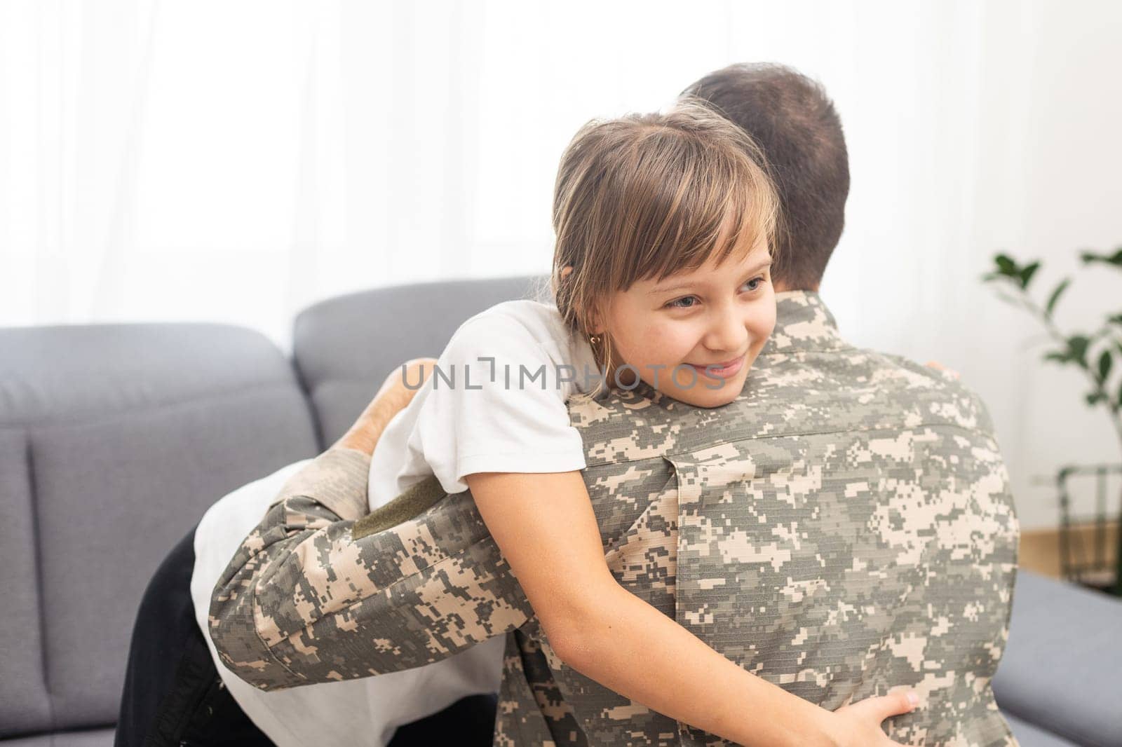 pretty little girl hugging her military father by Andelov13