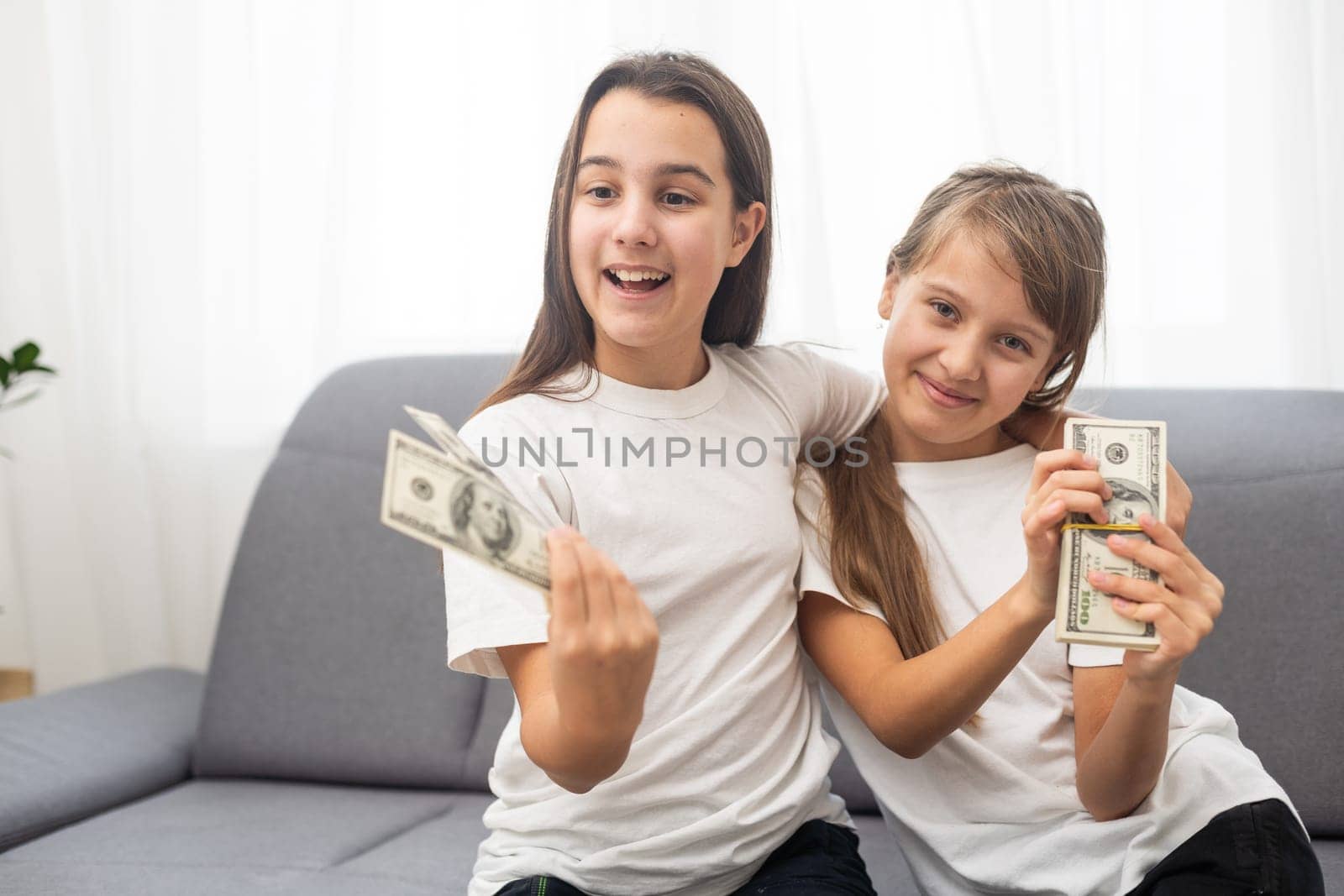 Portrait of two business children with US Dollars as symbol of bribe in an envelope. High quality photo