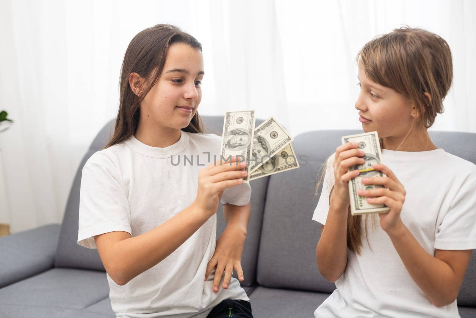 Portrait of two business children with US Dollars as symbol of bribe in an envelope. High quality photo