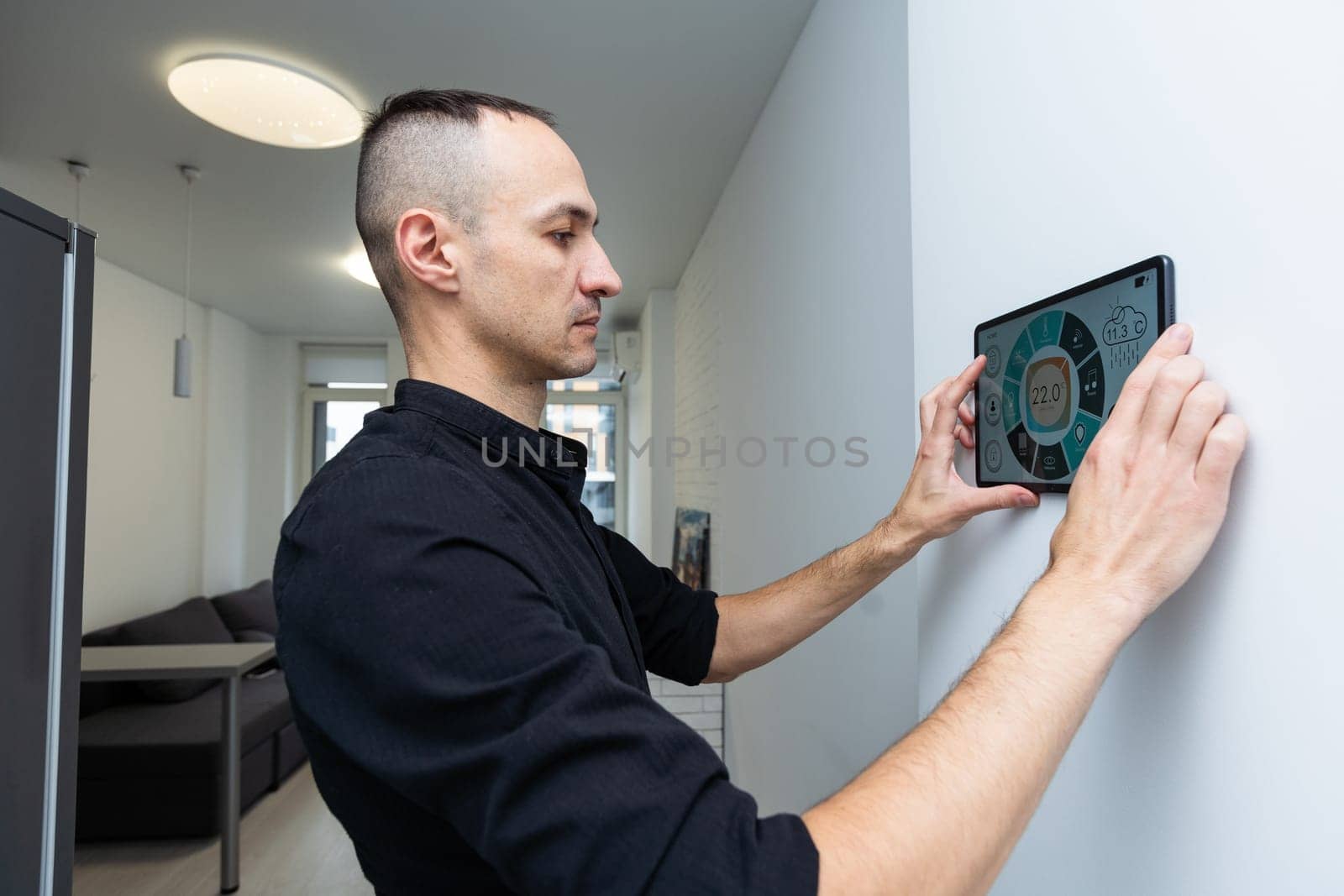 automation, internet of things and technology concept - man looking at tablet pc computer at smart home. High quality photo