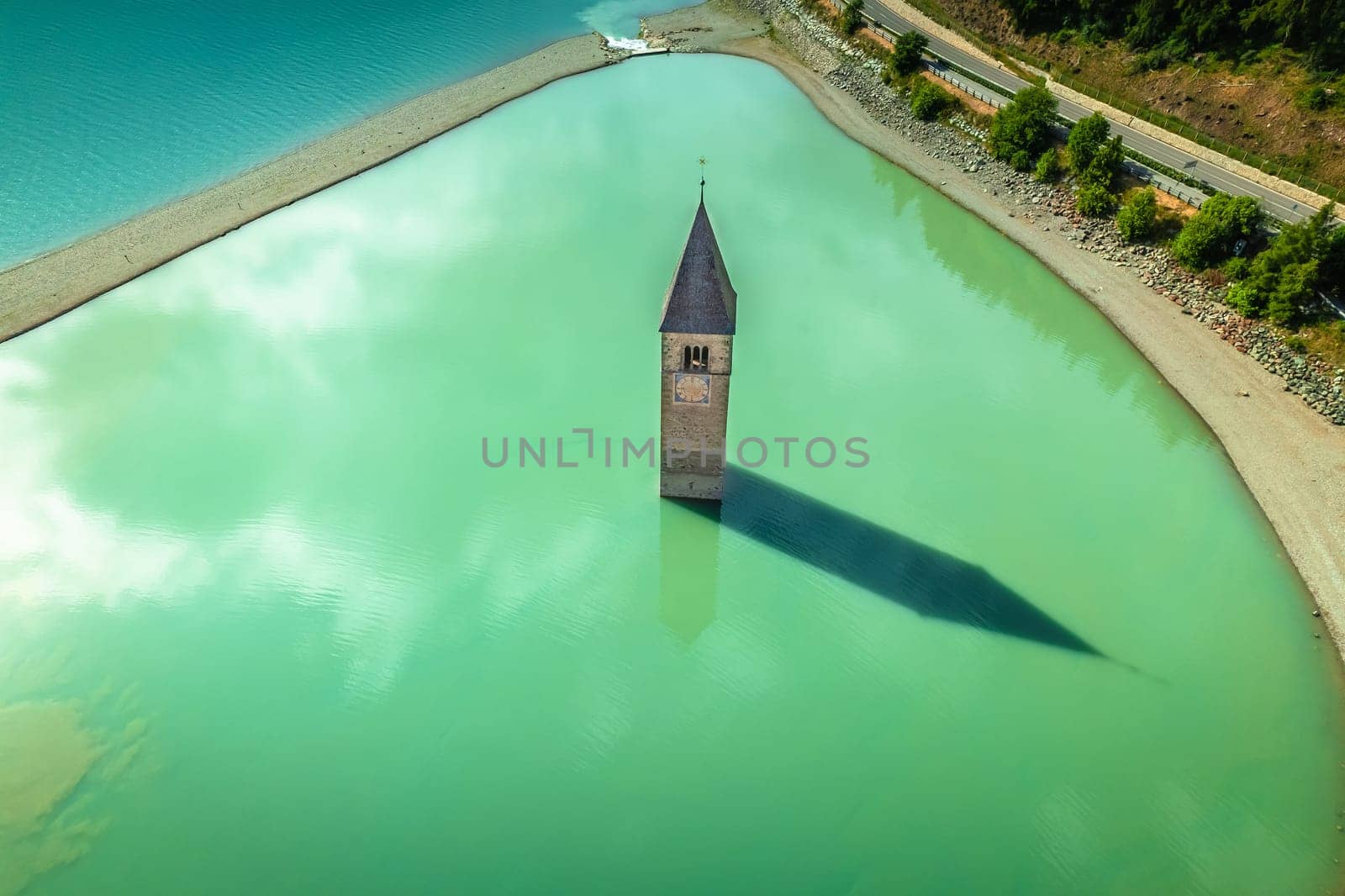 Curon Venosta. Submerged bell Tower in Graun im Vinschgau on Lake Reschen Alpine landscape aerial view, South Tyrol region Italy