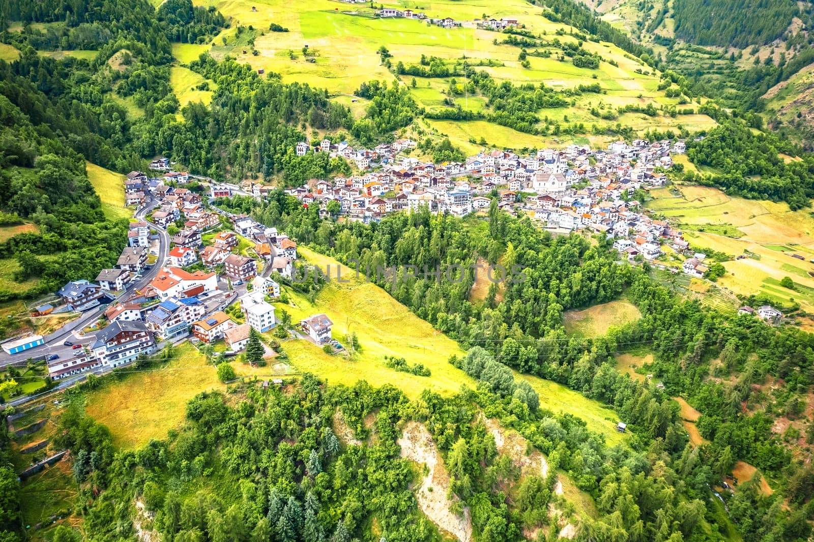 Stelvio village or Stilfs in Dolomites Alps landscape aerial view, province of South Tyrol in northern Italy.