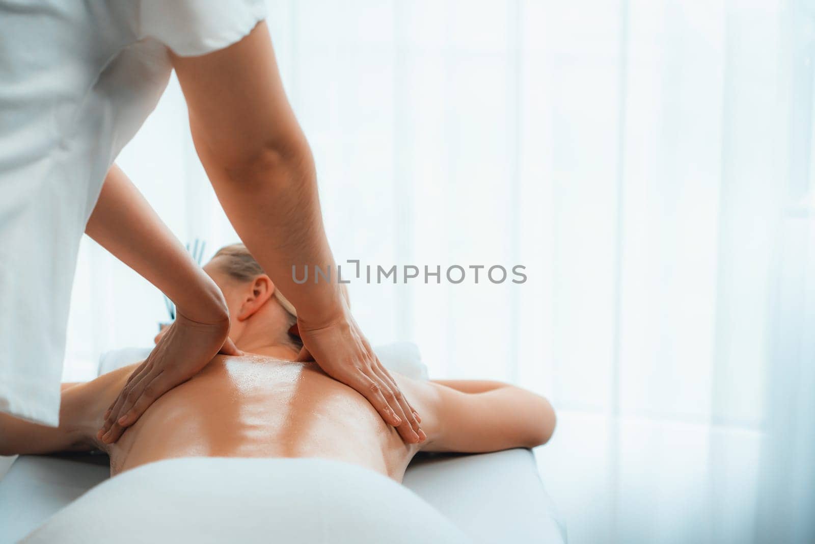 Caucasian woman customer enjoying relaxing anti-stress massage. Quiescent by biancoblue