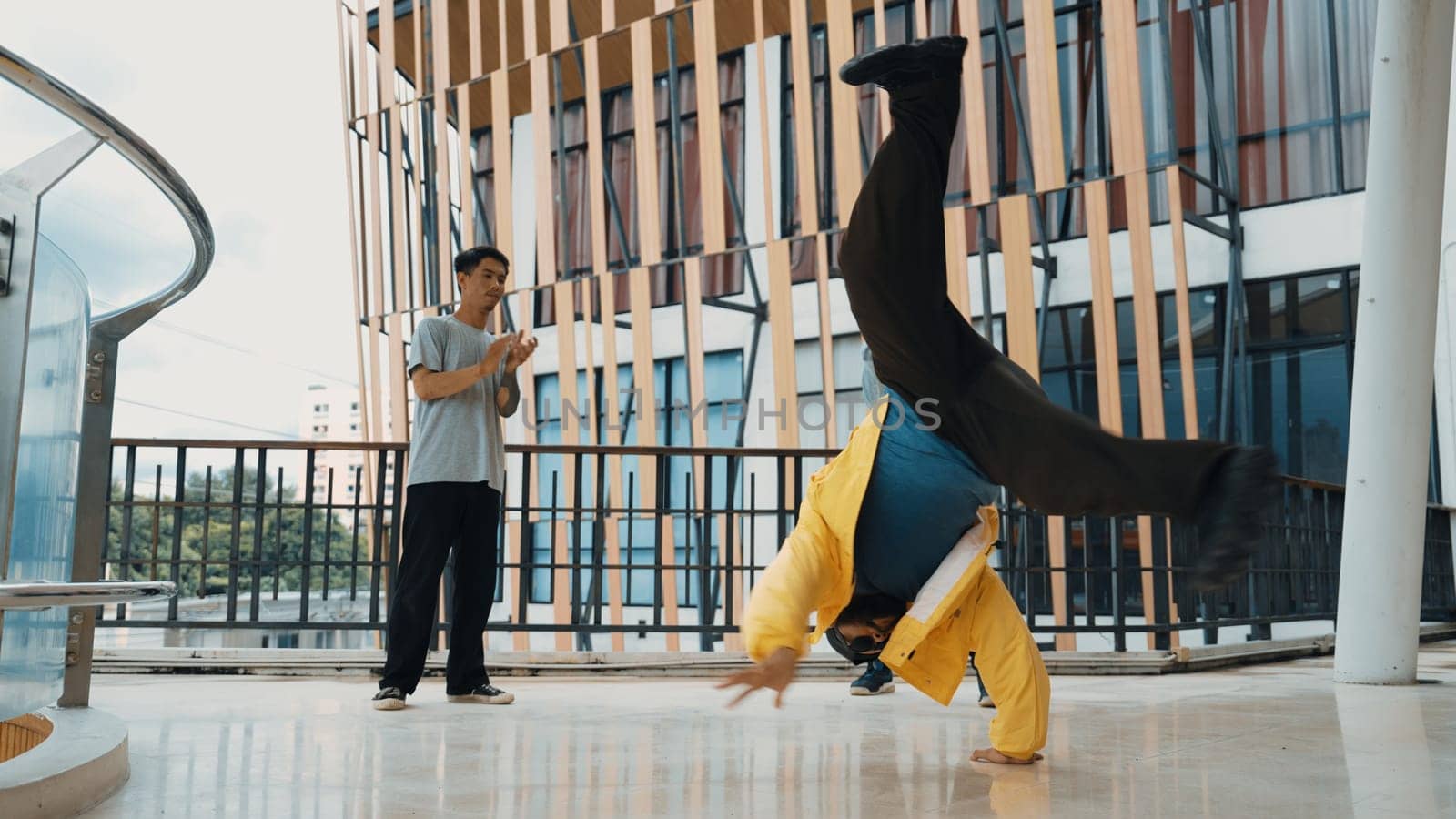 Hip hop team dance break dance while multicultural friend surrounded and clapping hands to cheer or encourage his friend to dance. Active and energetic street dance. Outdoor sport 2024. Endeavor.