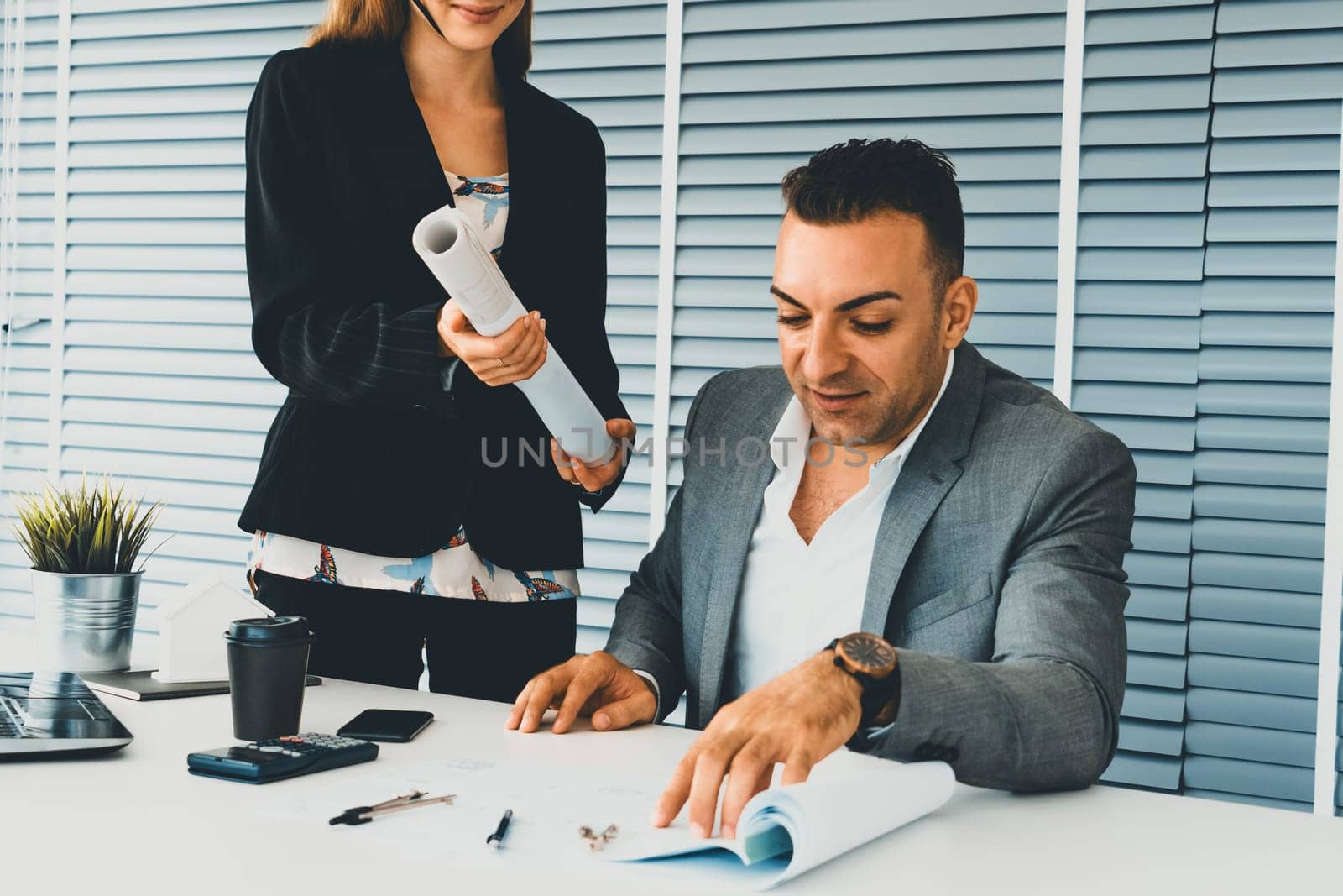 Businessman executive checking work while meeting discussion with businesswoman worker in modern workplace office. People corporate business team concept. uds