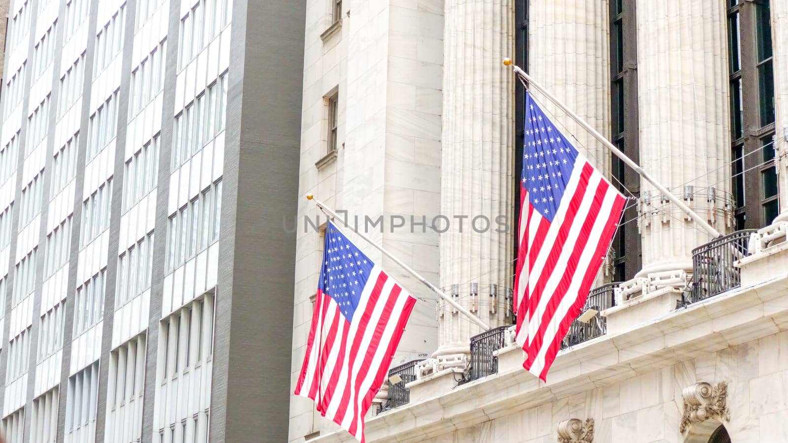 American flags on the main facade of the New York Stock Exchange - NYSE Building in the Financial District of Lower Manhattan in New York City is seen on July 4th, 2023 by JuliaDorian
