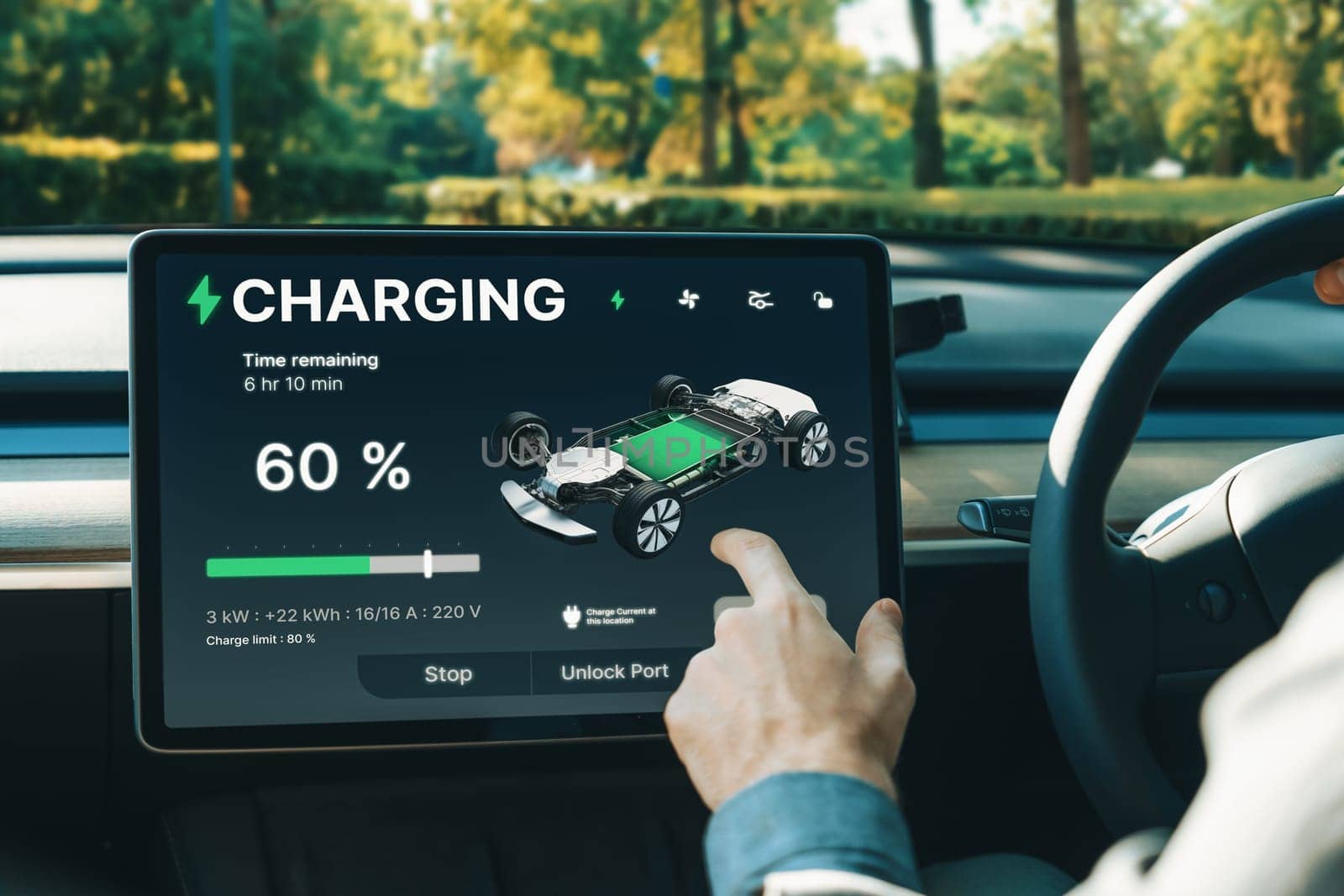 Electric car driver checks battery charging status app screen in car innards by biancoblue