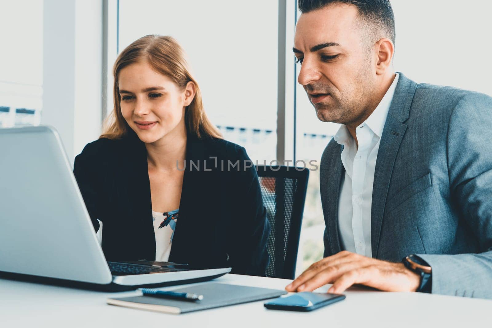 Businessman executive is in meeting discussion with a businesswoman worker in modern workplace office. People corporate business team concept. uds