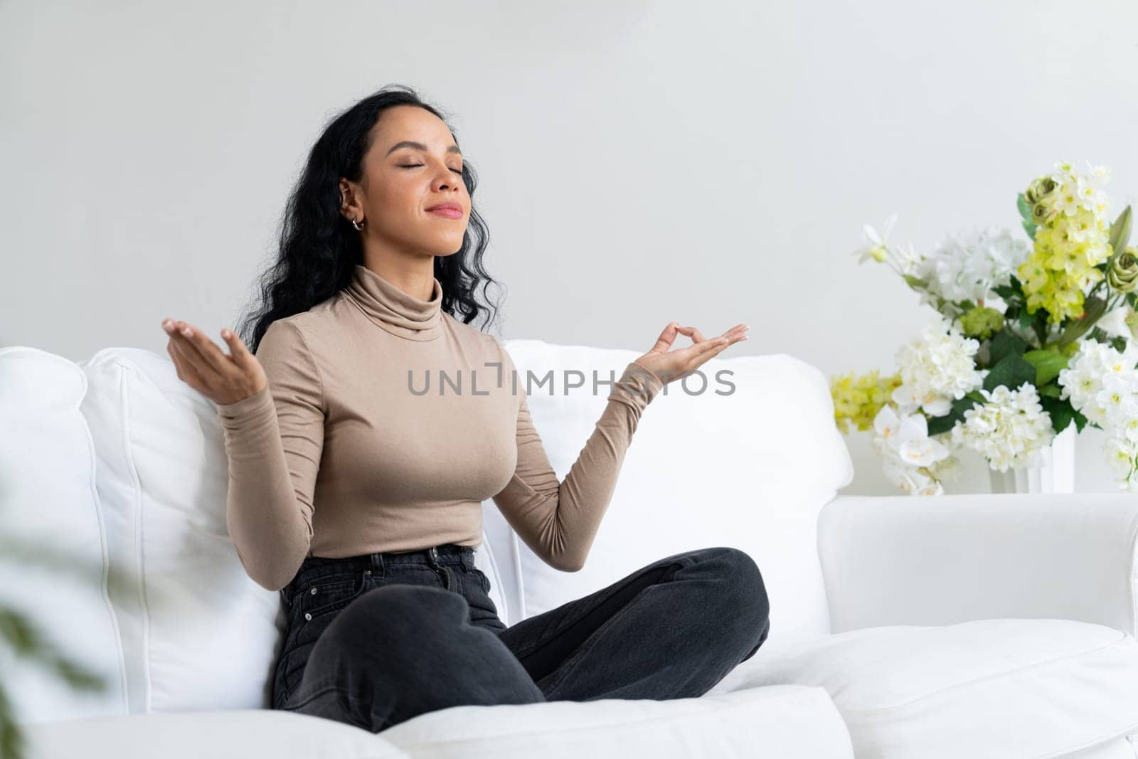 Young African American woman practice crucial mindful meditation at home living room for improving mental health strength and peaceful beautiful living