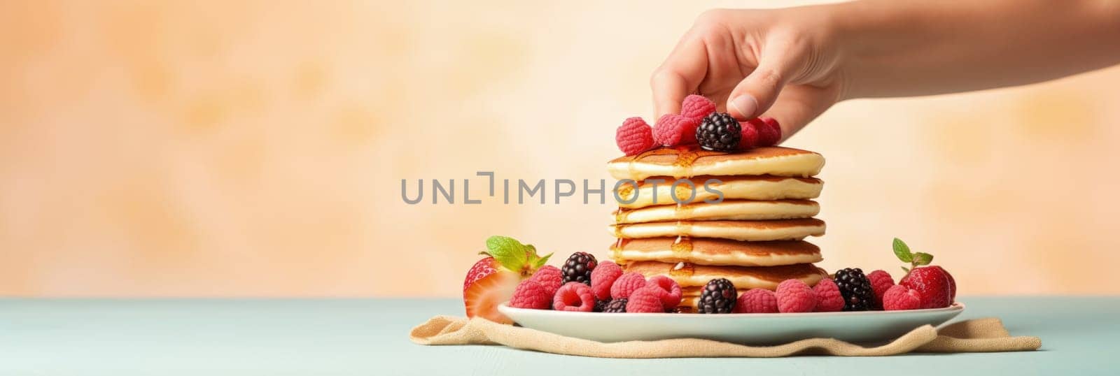 Stack of pancakes with berries. Advertising banner, web banner. Lush delicious pancakes with blueberries, raspberries and syrup for homemade breakfast. Lifestyle concept of food, cooking. Copy space