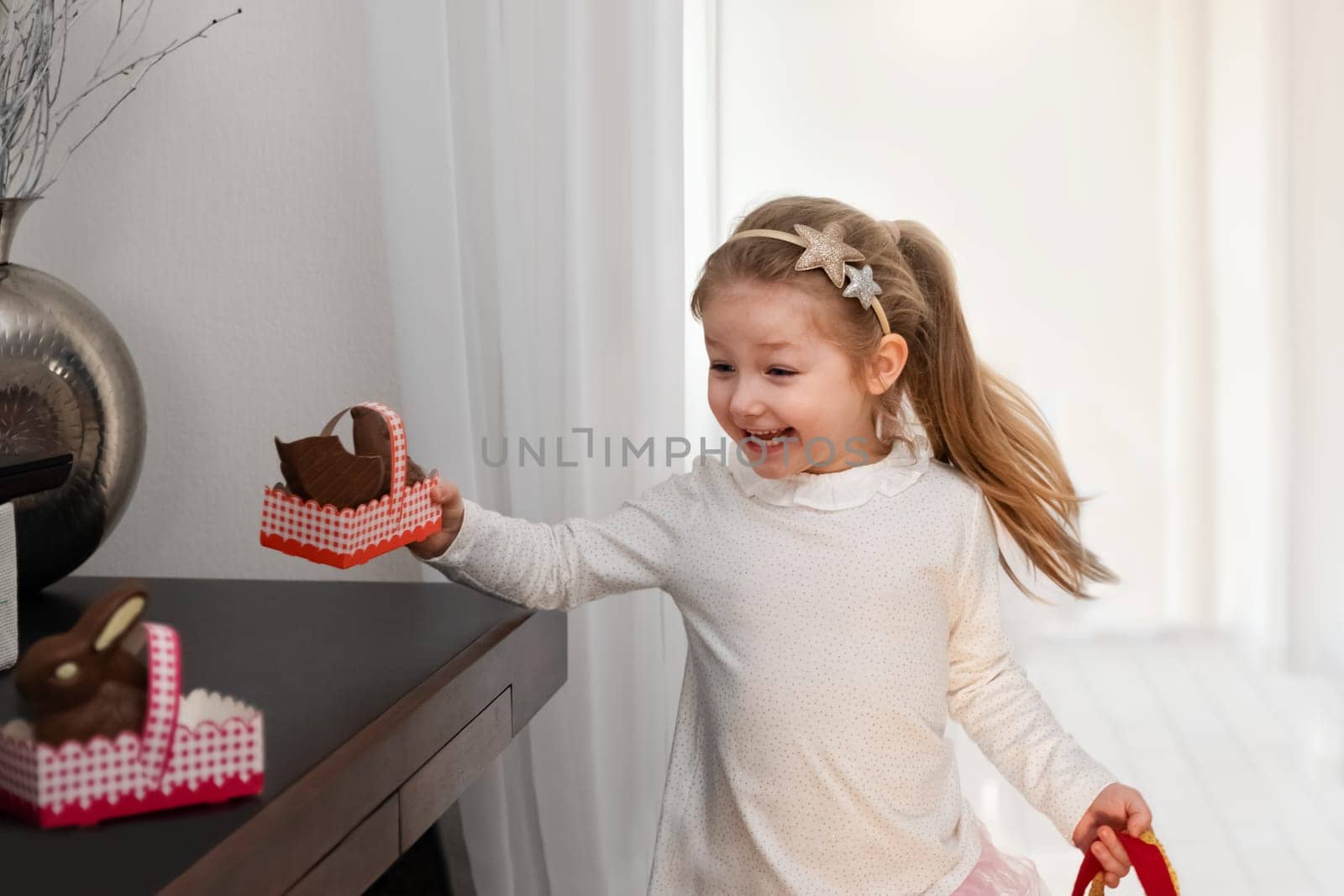 A girl searches for chocolate bunnies for Easter during self-isolation during the coronavirus pandemic