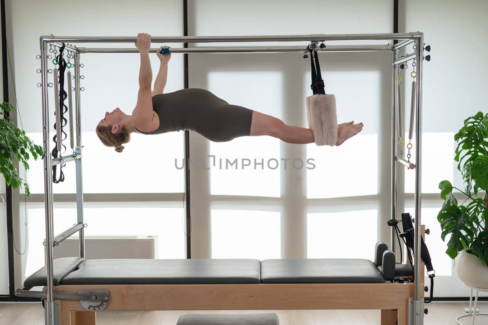Pregnant woman doing pilates on a reformer