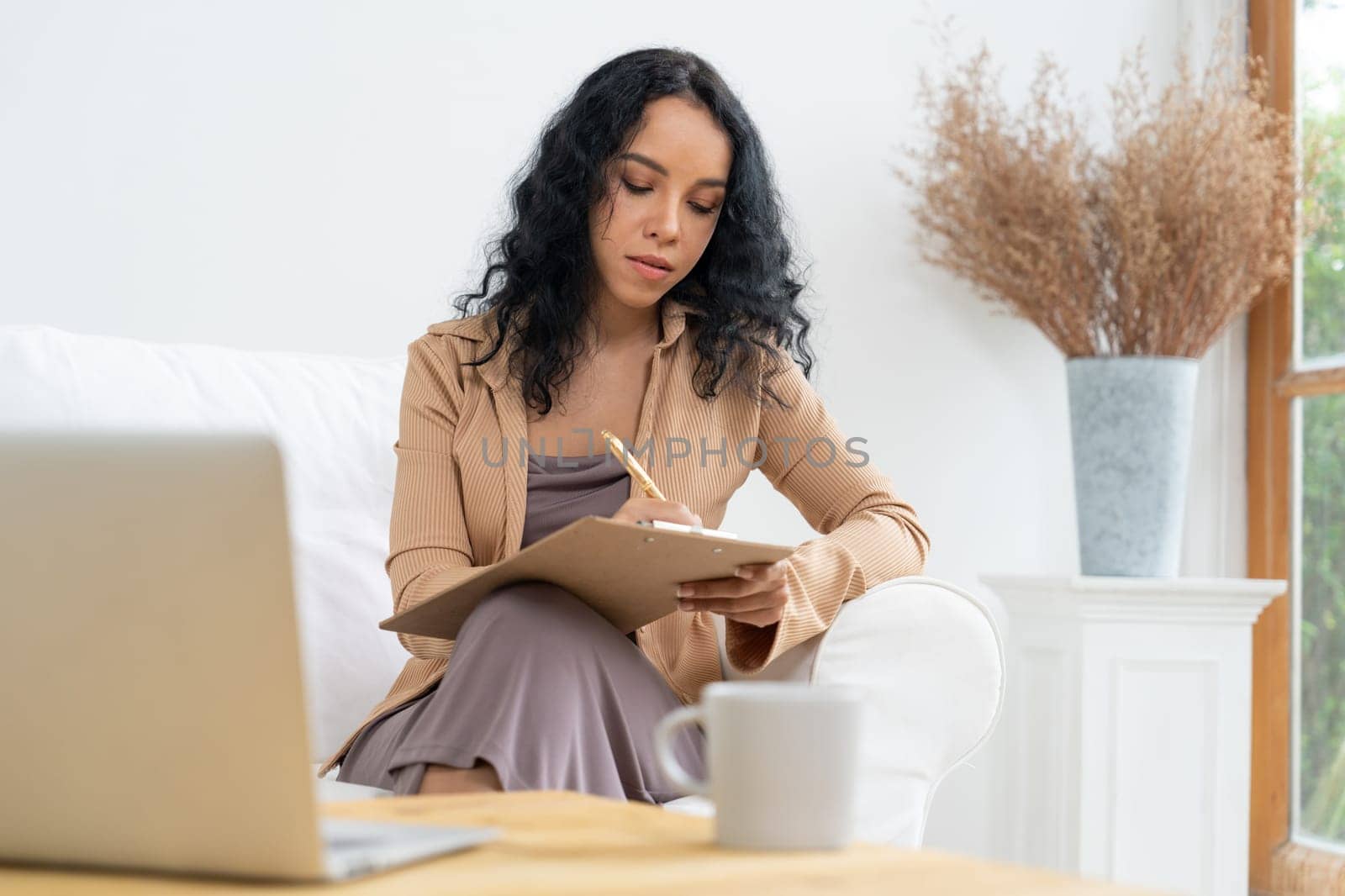 African-American woman using laptop computer for crucial work by biancoblue