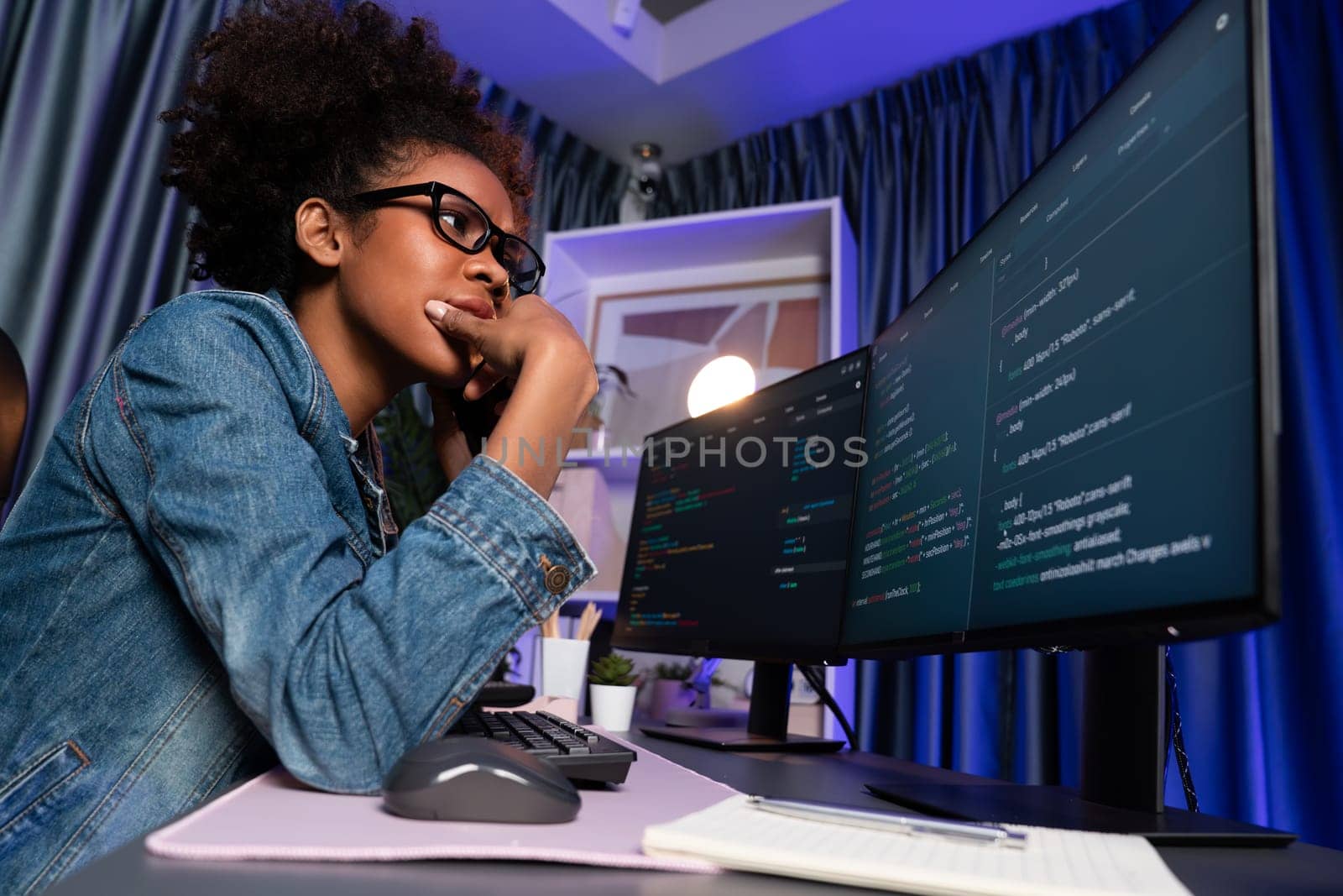 Young African American IT developer concentrating on monitor screen laptop with codding program in data of application and website, Concept of creating innovative html updated version. Tastemaker.