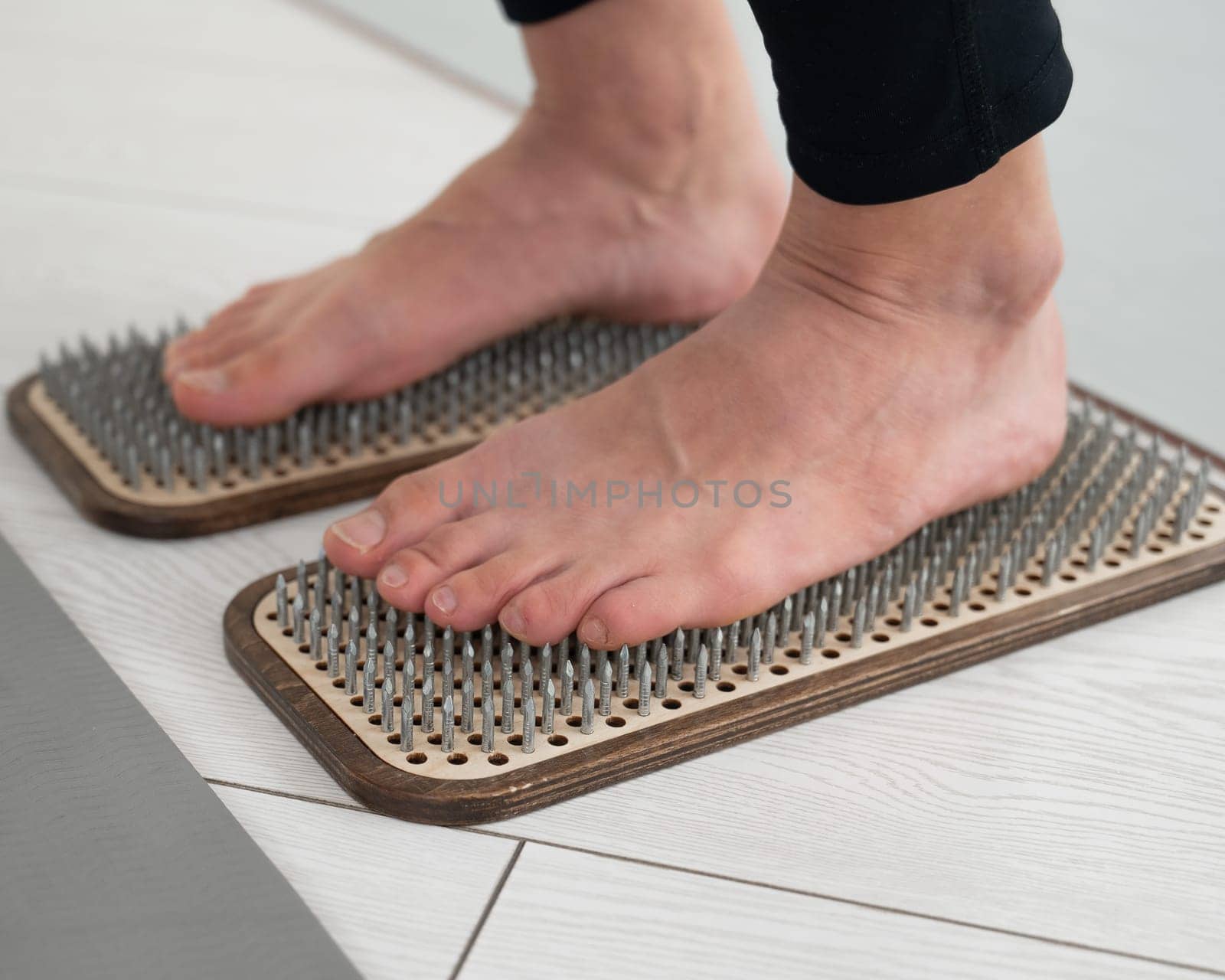 Close-up of female feet on sadhu boards