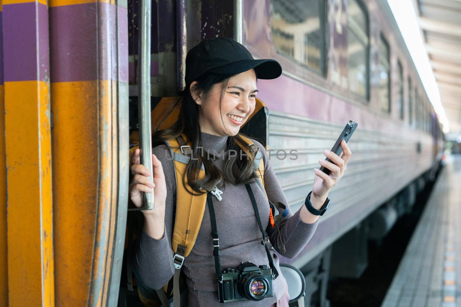 Woman using mobile phone for looking at map while travel by train. travel concept.