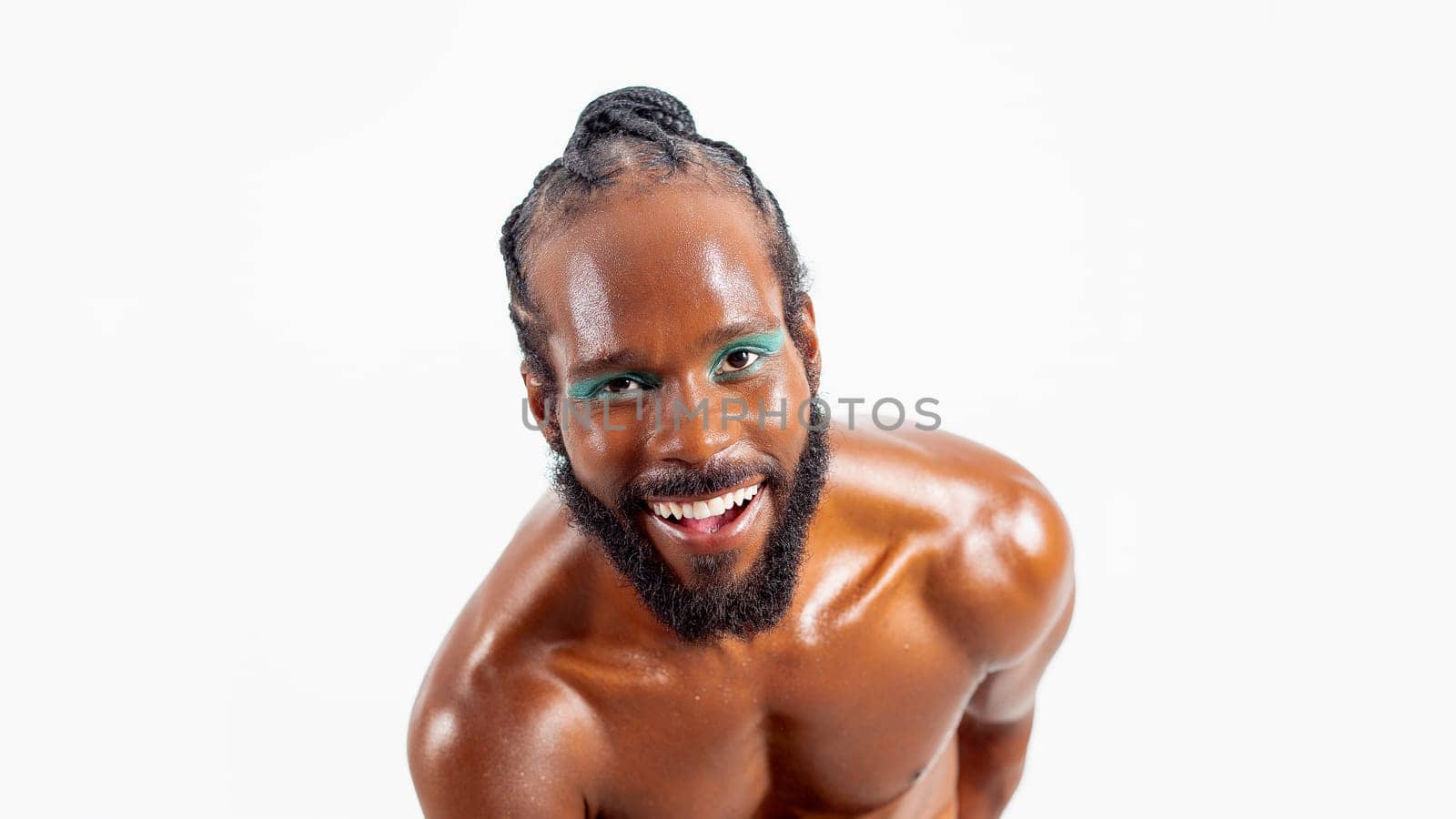Smiling african-american bearded gay man with bright makeup isolated on white background. Exudes sense of pride and individuality. Diversity power of personality.