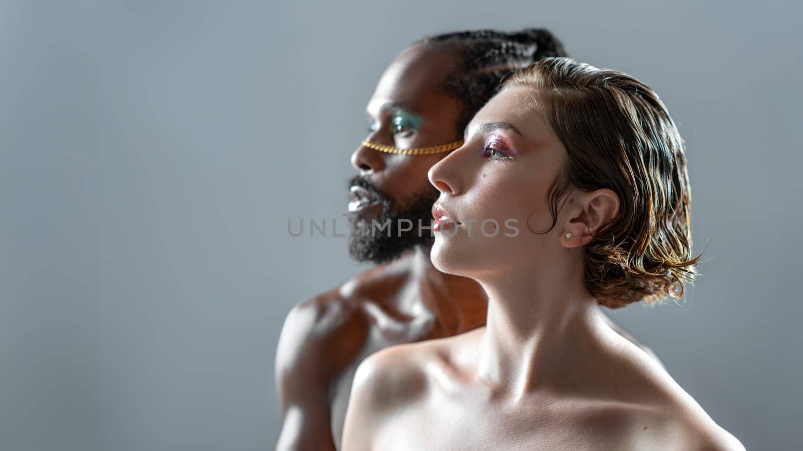 Gender equality concept. Gay male and female wearing make up close up portrait side view isolated on white. Life is beautiful with your bestie by your side. Studio shot of two LGBT people