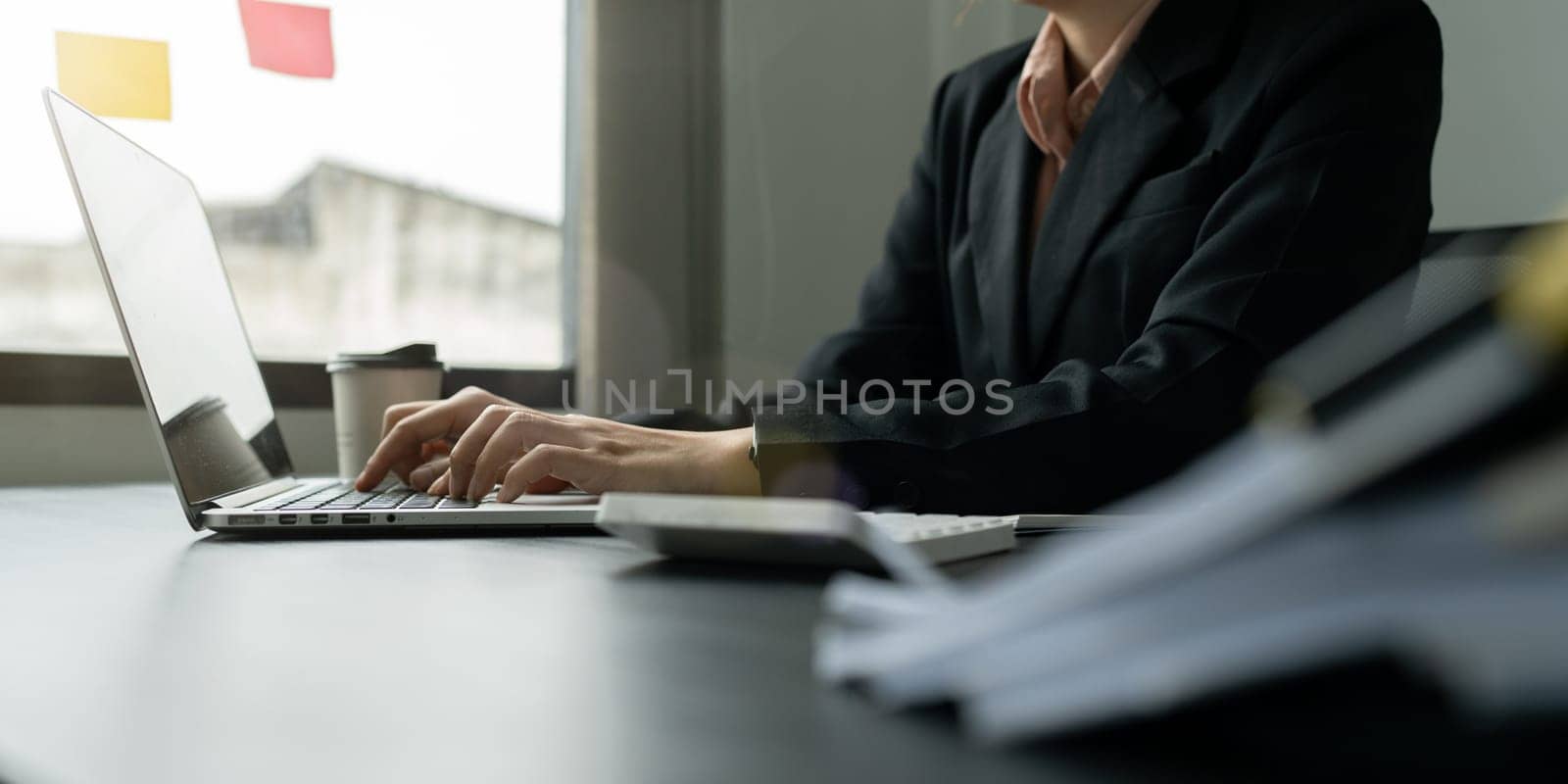 Cropped image of professional businesswoman working at her office via laptop by itchaznong