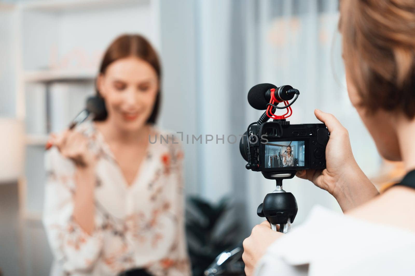 Woman influencer shoot live streaming vlog video review makeup utmost social media or blog. Happy young girl with cosmetics studio lighting for marketing recording session broadcasting online.