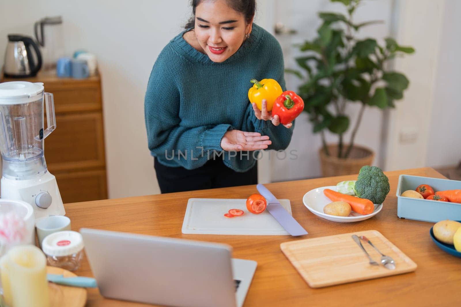 Fat woman cooking in kitchen. health care concept Eat health food to lose weight. Learn to make salads and healthy food from online by nateemee