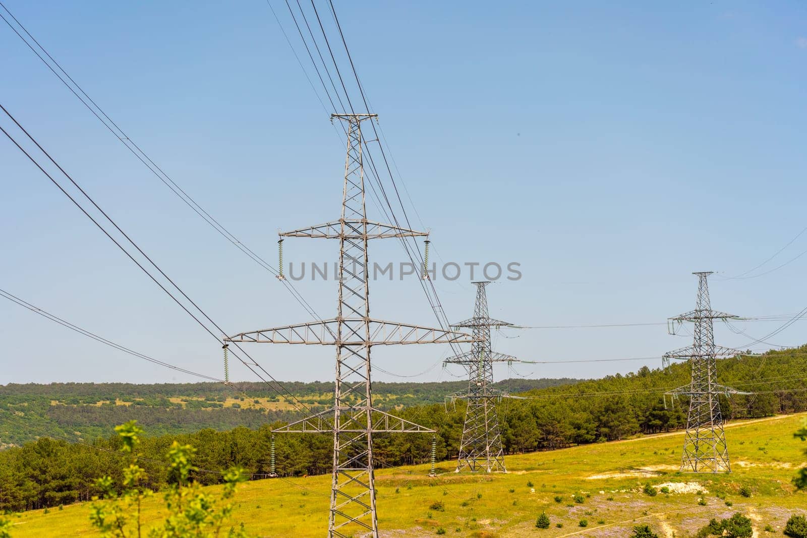 High voltage towers Electric pole. Power line support with wires for electricity transmission. High voltage grid tower with wire cable at distribution station. Energy industry, energy saving by Matiunina