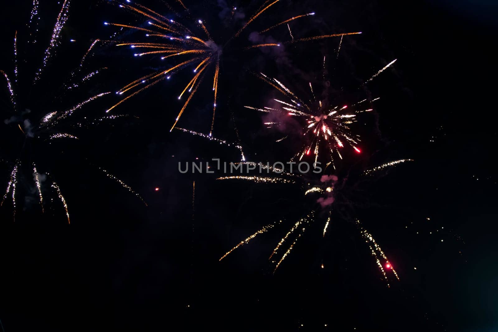 On a black background bokeh from explosions of colorful fireworks. by Sviatlana