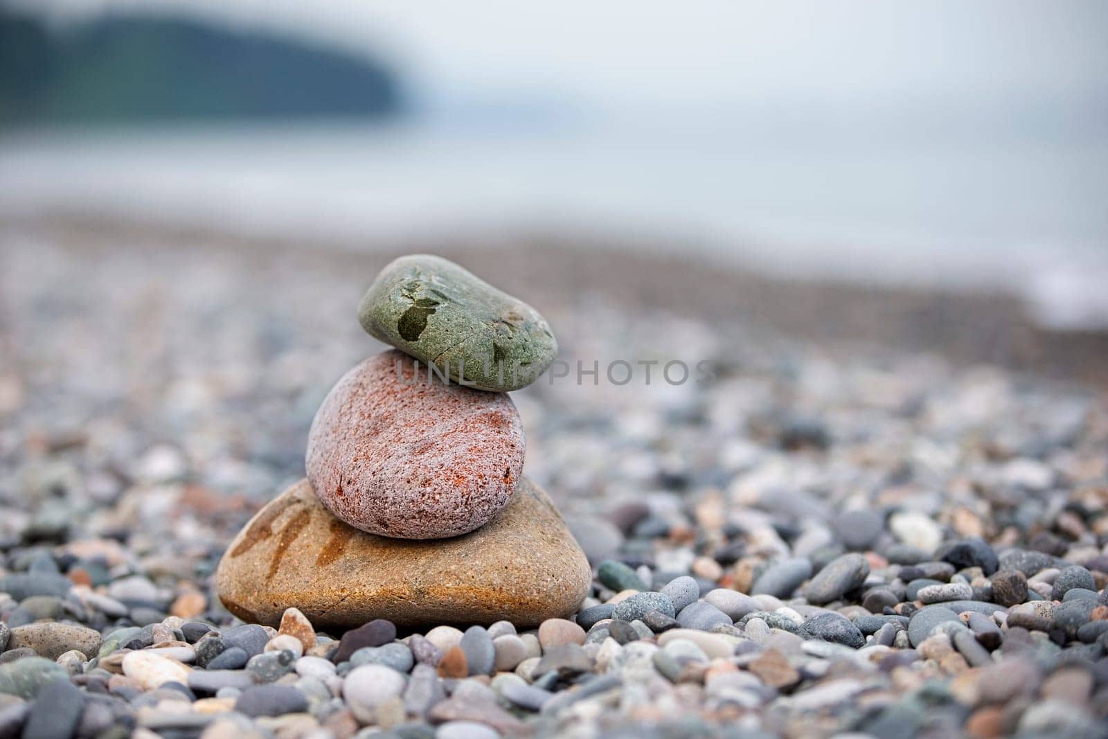 Pebbles on the seashore, large and small stones on the sea. by Sviatlana