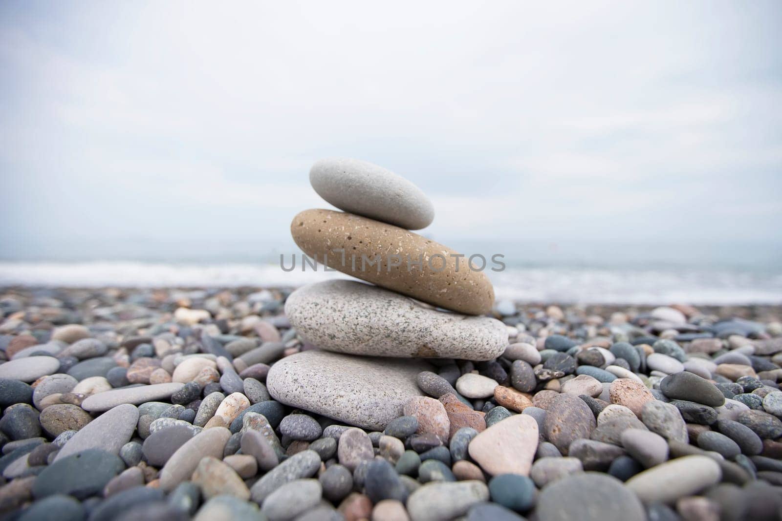 Pebbles on the seashore, large and small stones on the sea. by Sviatlana
