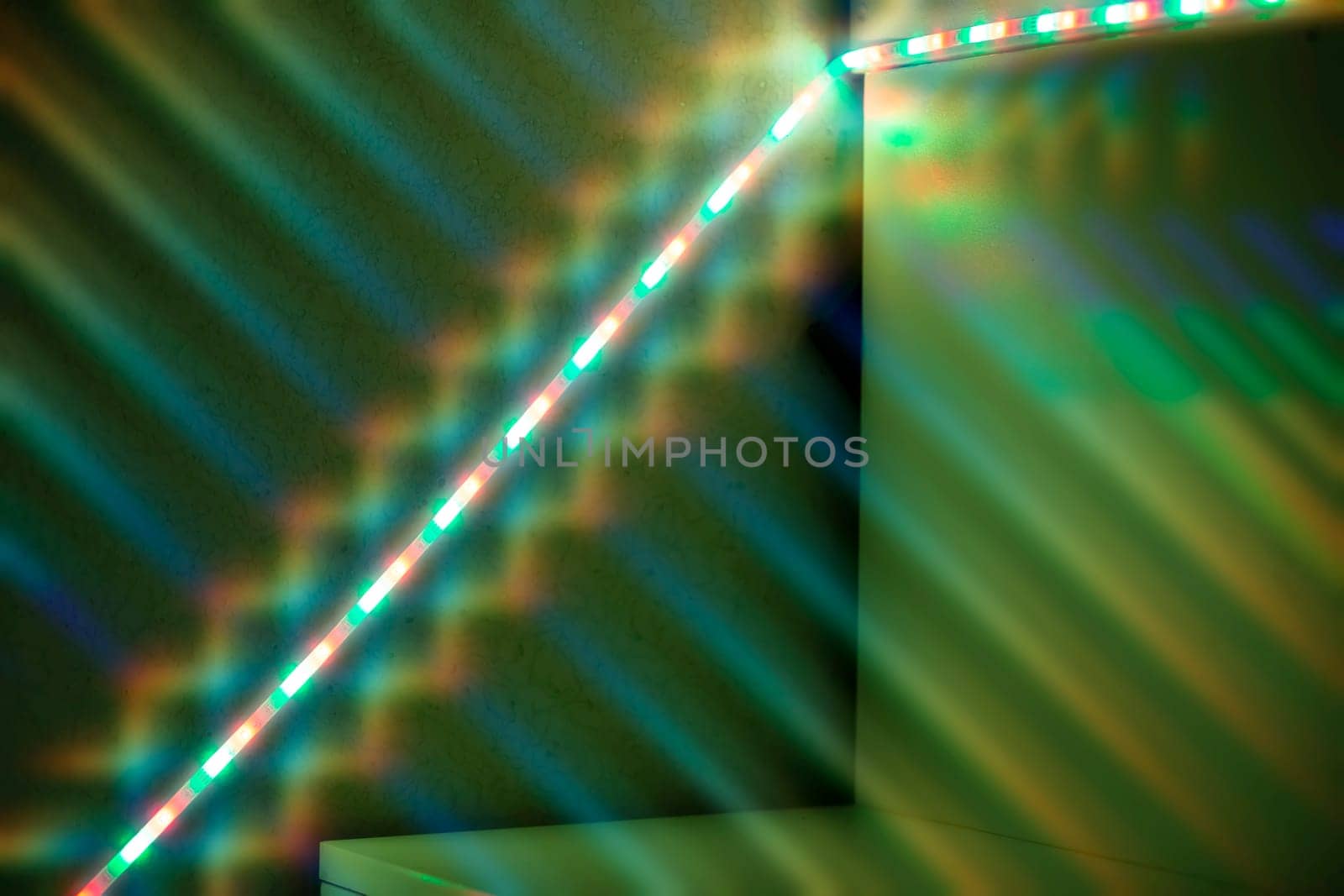 Light diode strip on a green texture wall.
