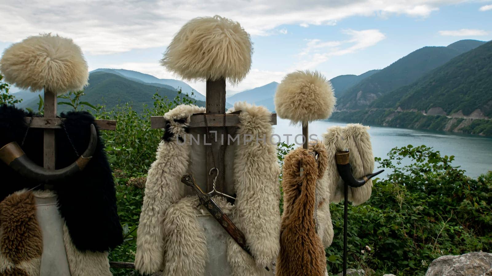 Georgian papakhas are sold to tourists against the backdrop of mountains. Journey along the military Georgian road.