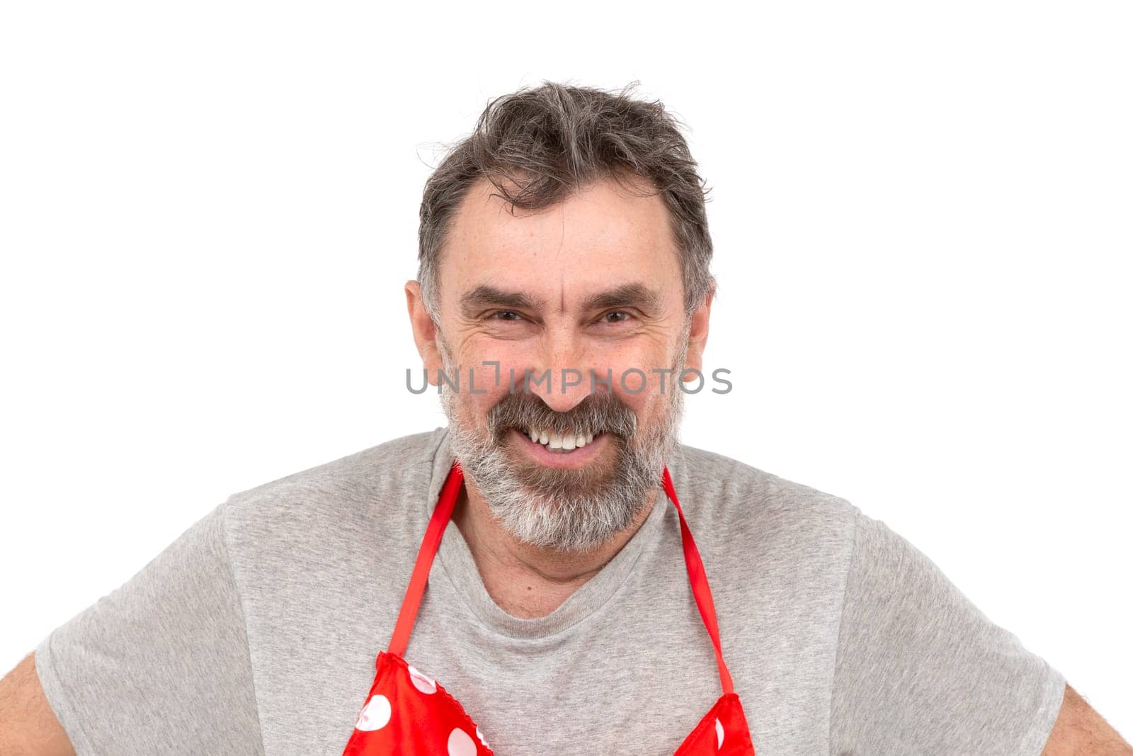 Elderly bearded man smiling at the camera on a white background.
