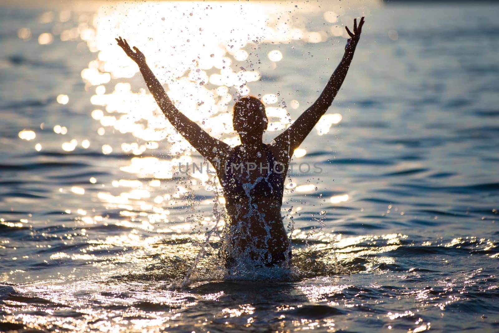 Silhouette of a woman with sea splashes. by Sviatlana