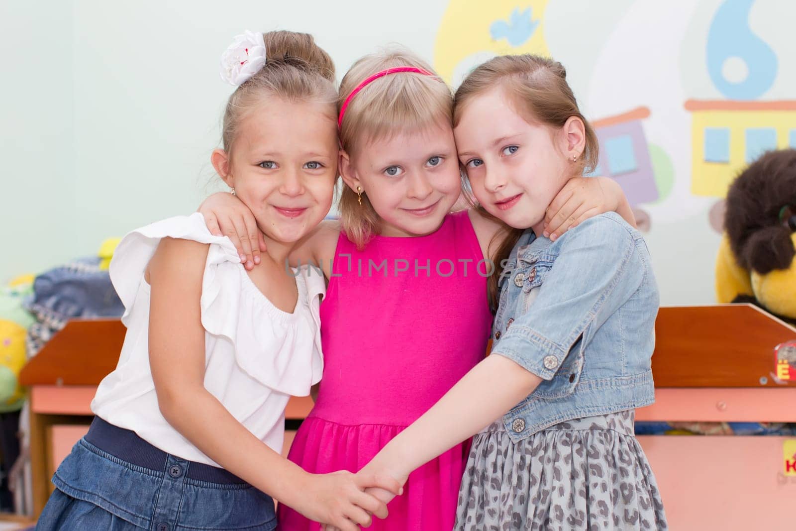 Belarus, Gomel, May 29, 2018. The kindergarten is central. Open Day.Three girl friends preschool girls.Girls from kindergarten
