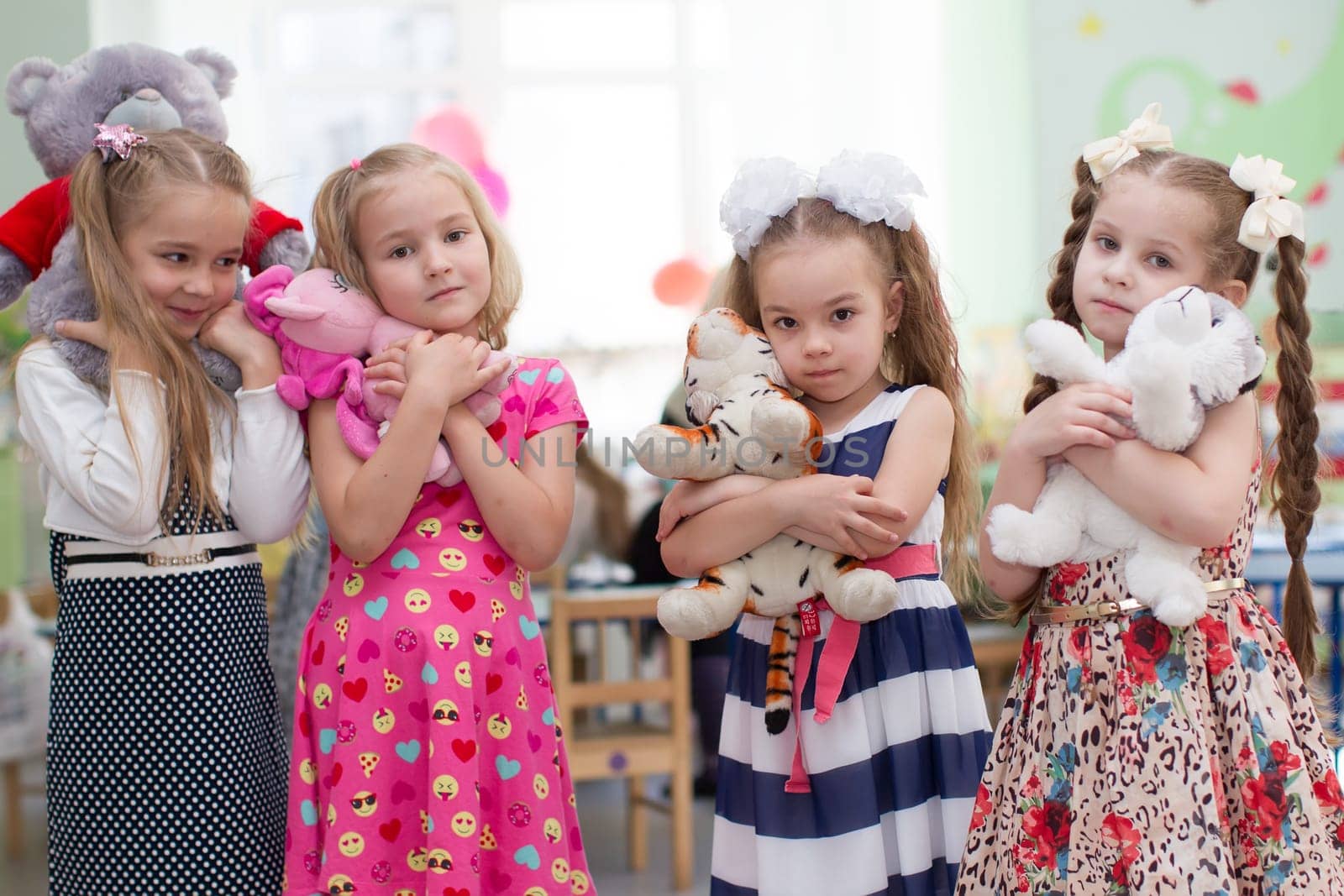 Belarus, Gomel, May 29, 2018. The kindergarten is central. Open Day.Girls preschool girls with soft toys in their hands.Girlfriends in kindergarten.Six-year-old girls