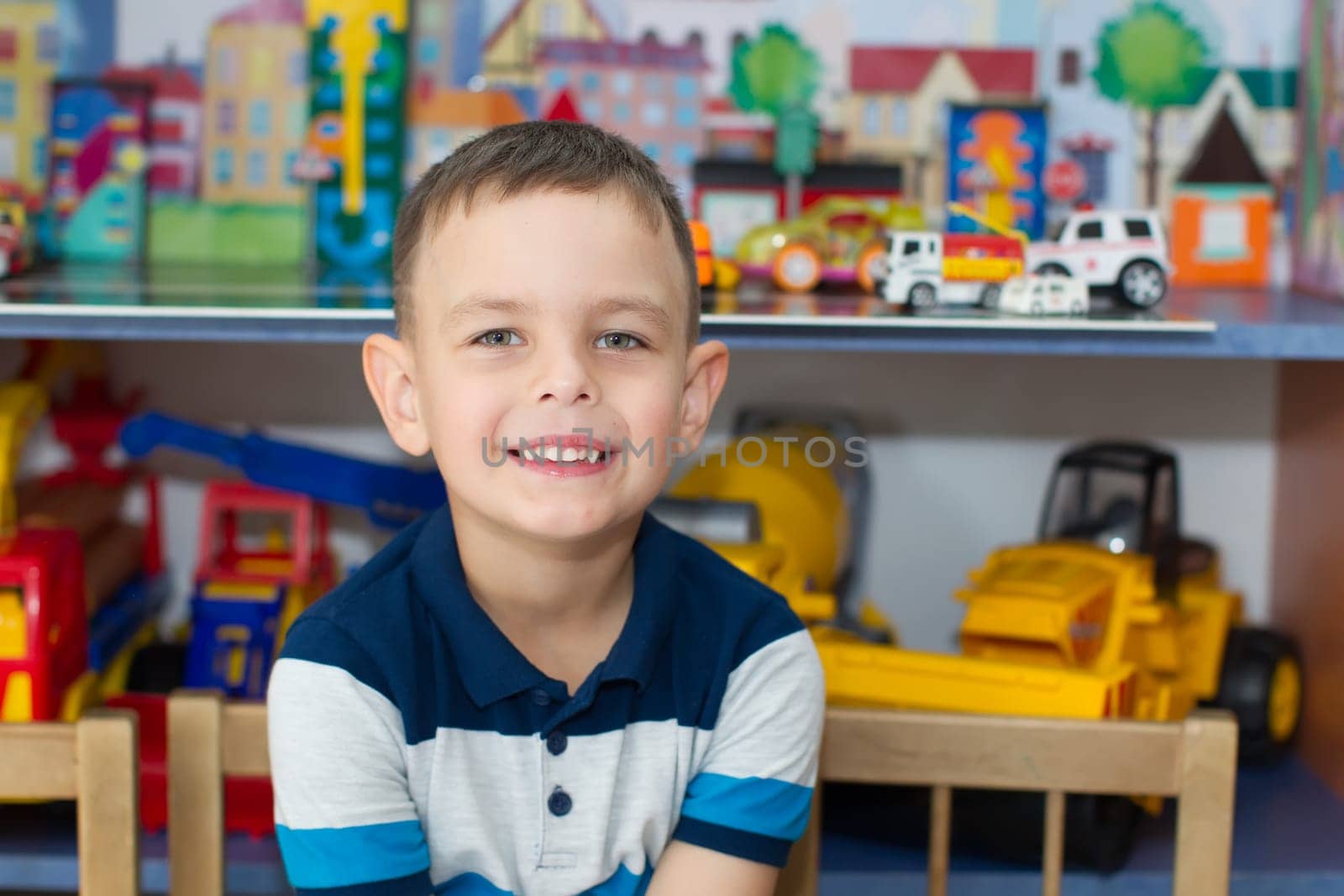 Belarus, Gomel, May 29, 2018. The kindergarten is central. Open Day.A preschool boy is smiling at a toy background.Cheerful child in kindergarten