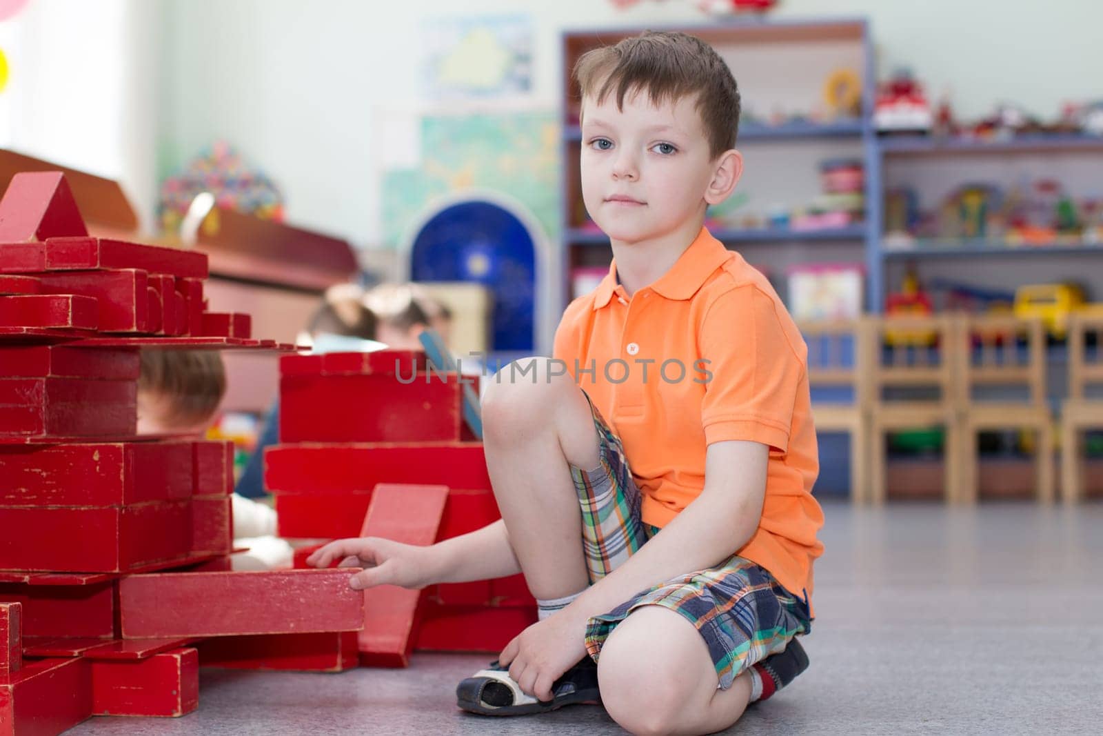 Belarus, Gomel, May 29, 2018. The kindergarten is central. Open Day.The boy plays the designer. The child builds out of cubes
