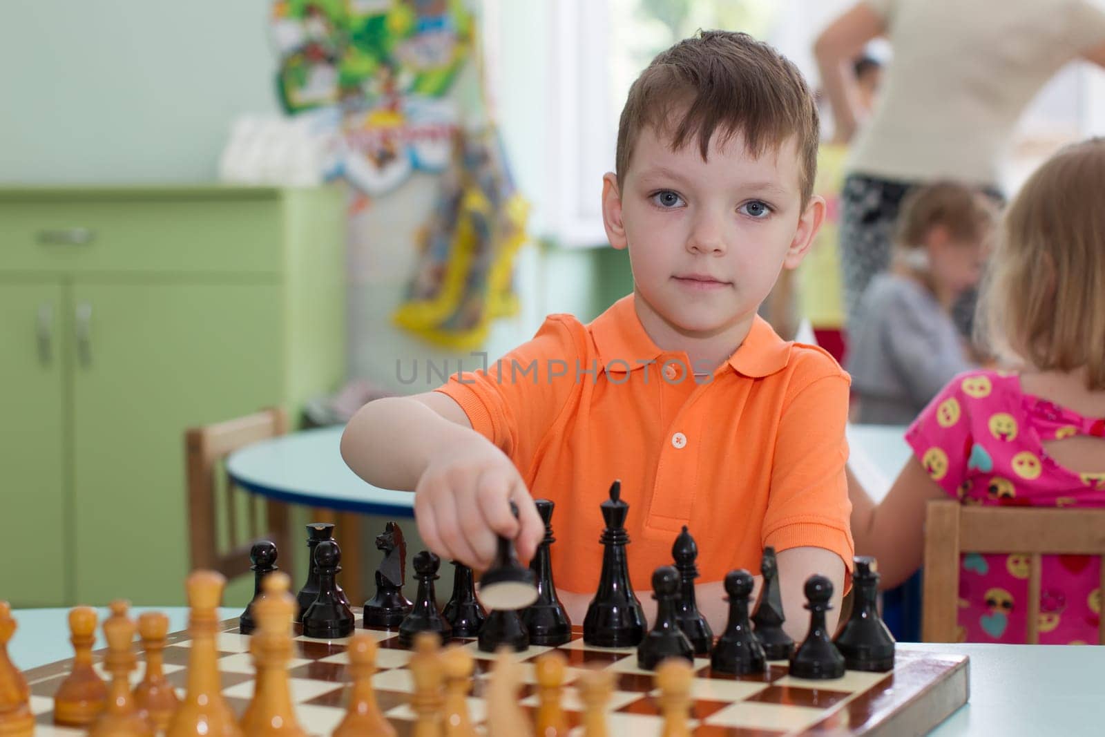 Belarus, Gomel, May 29, 2018. The kindergarten is central. Open Day.Boy preschooler and play chess by Sviatlana