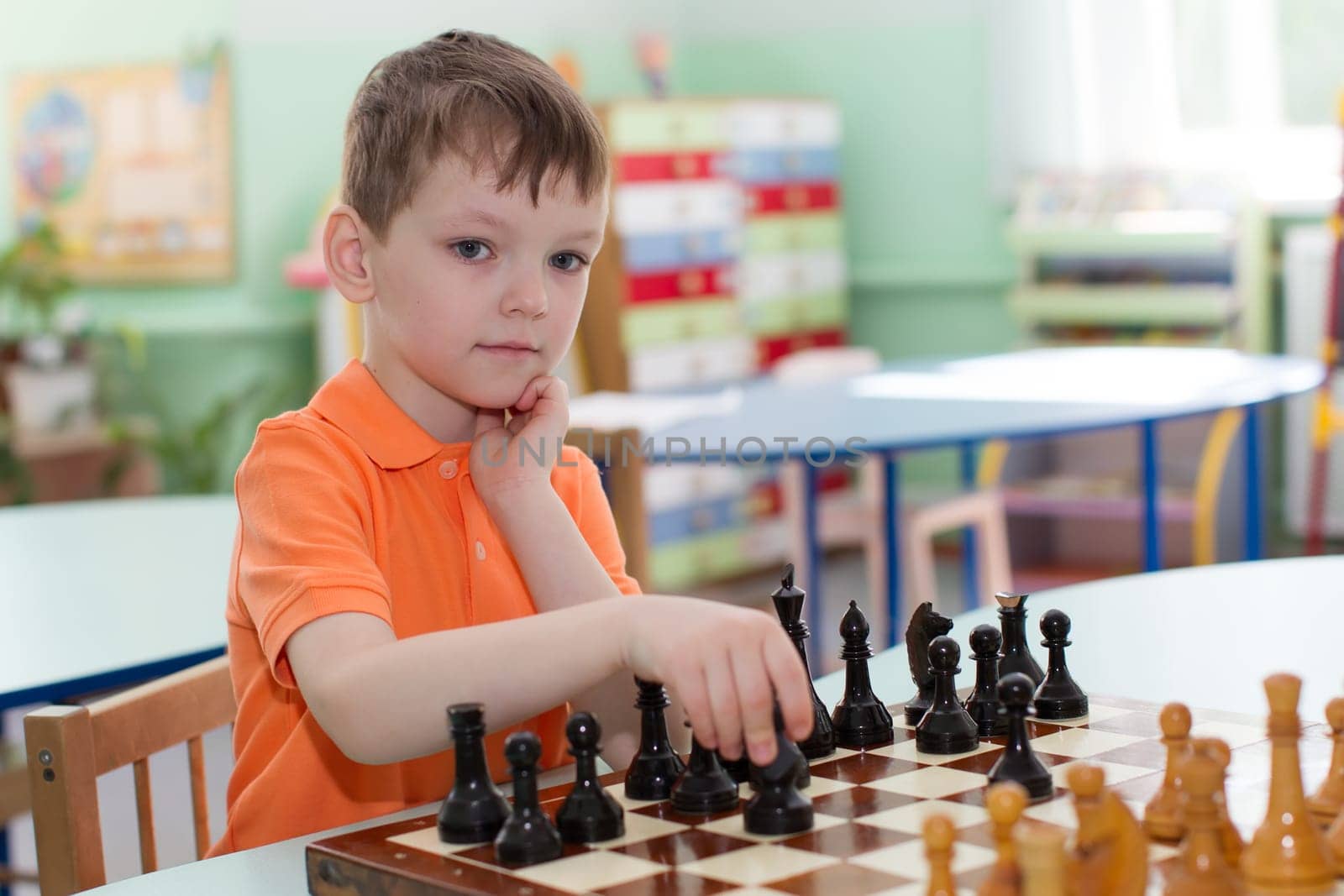 Belarus, Gomel, May 29, 2018. The kindergarten is central. Open Day.Children play chess by Sviatlana