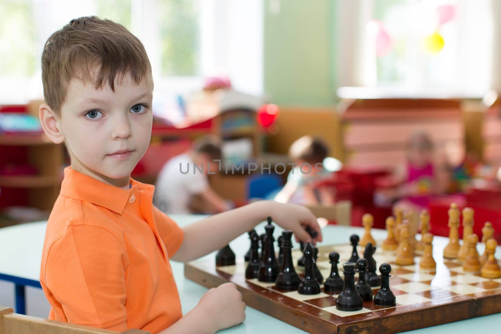Belarus, Gomel, May 29, 2018. The kindergarten is central. Open Day.Boy playing chess in primary school by Sviatlana