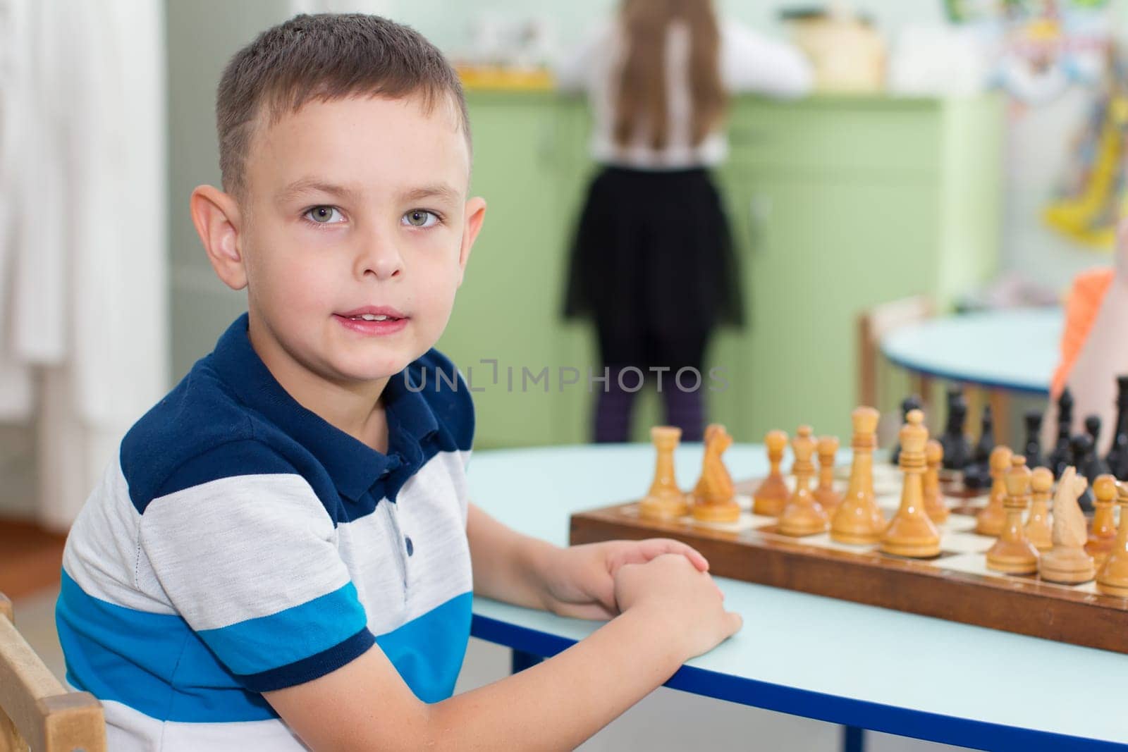 Belarus, Gomel, May 29, 2018. The kindergarten is central. Open Day.Six year old boy with chess by Sviatlana
