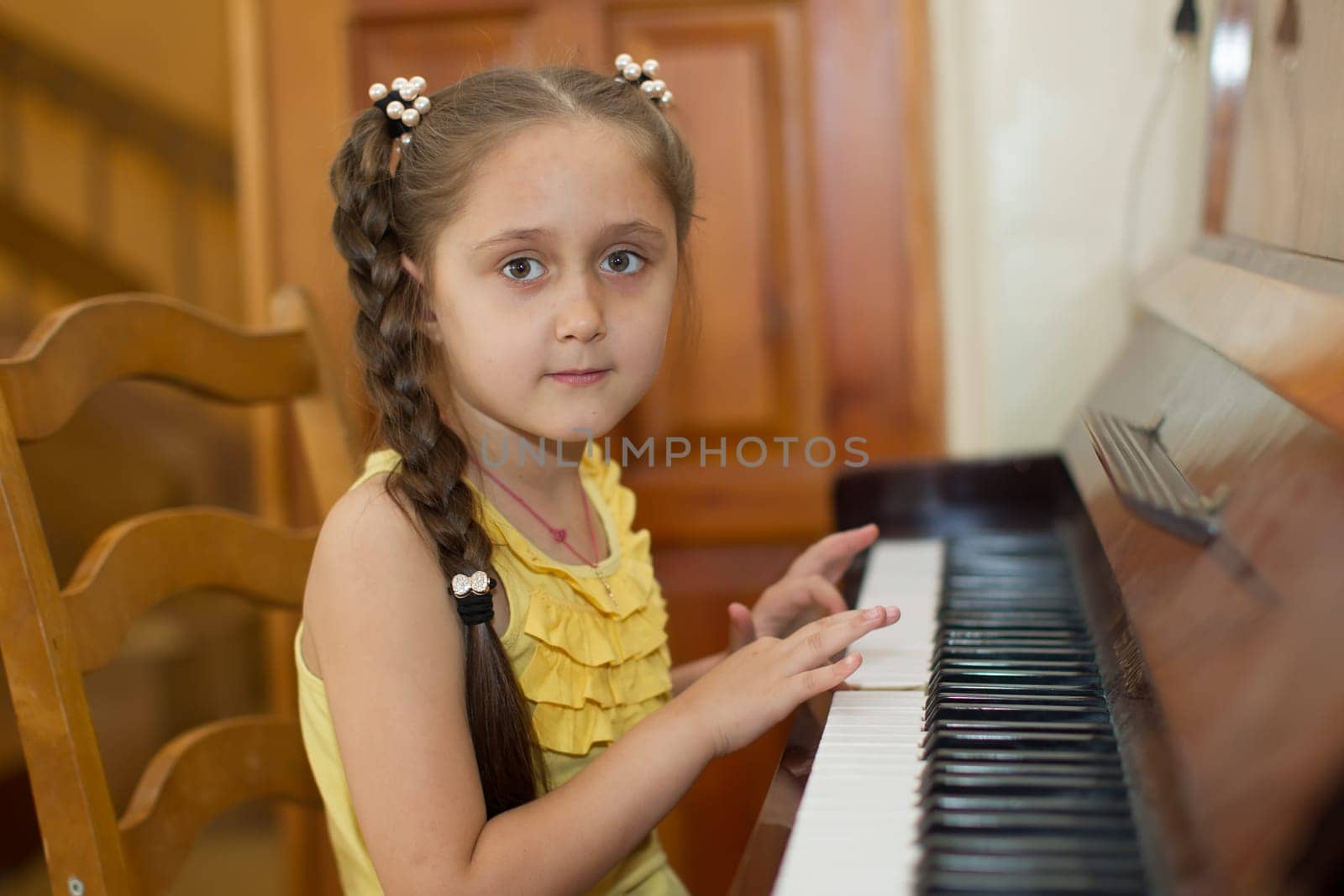 Belarus, Gomel, May 29, 2018. The kindergarten is central. Open Day.Child plays the piano.Preschool Music Education for Children