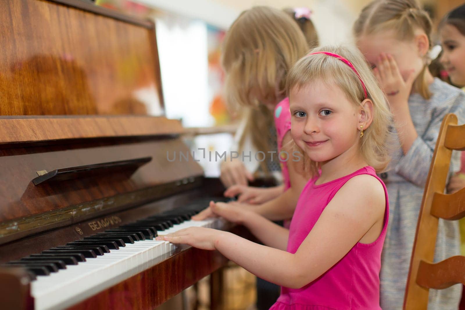 Belarus, Gomel, May 29, 2018. The kindergarten is central. Open Day.Child plays the piano.Preschool Music Education for Children by Sviatlana