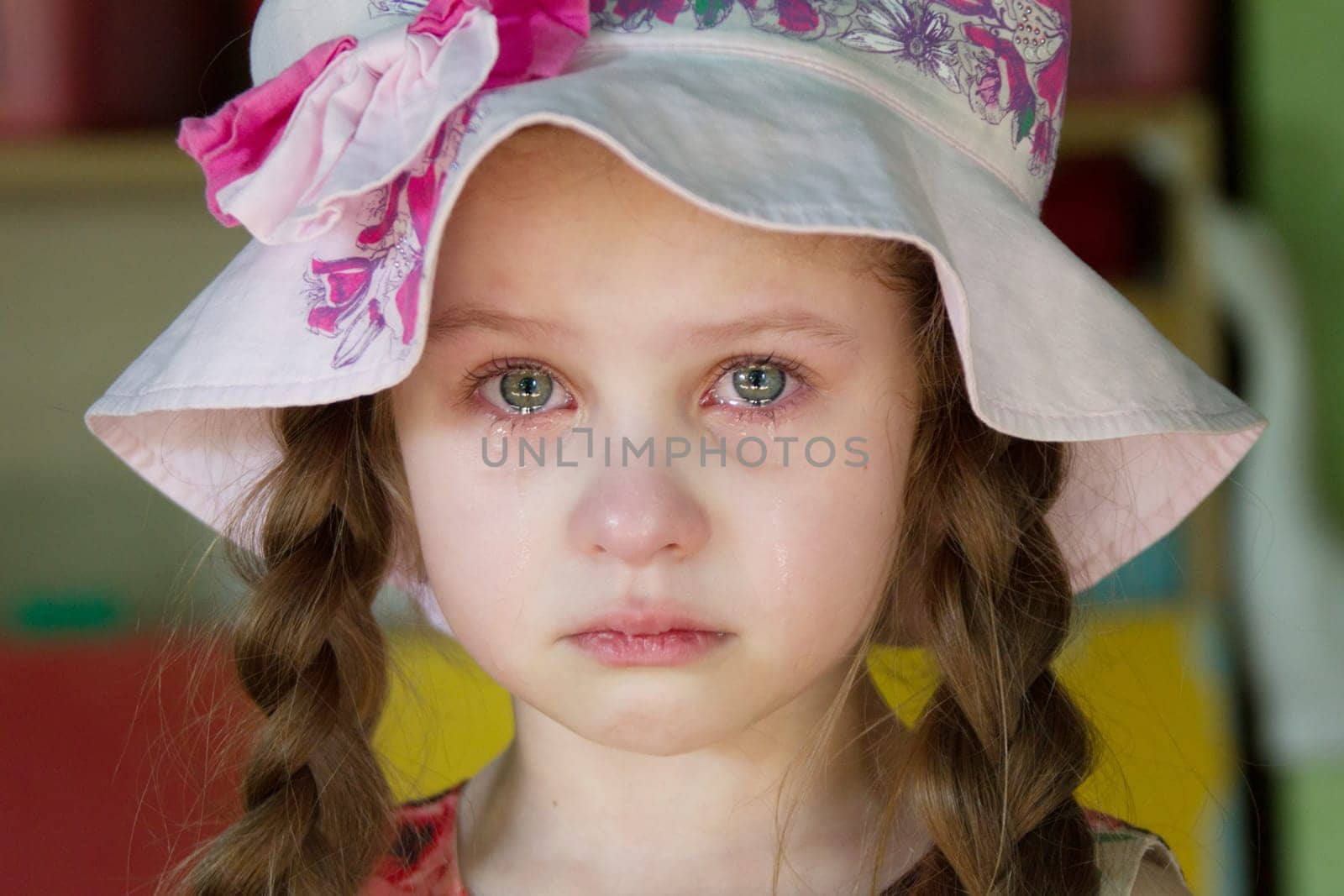 Belarus, Gomel, May 29, 2018. The kindergarten is central. Open Day.The little girl is crying. Tears on the face of the child. by Sviatlana