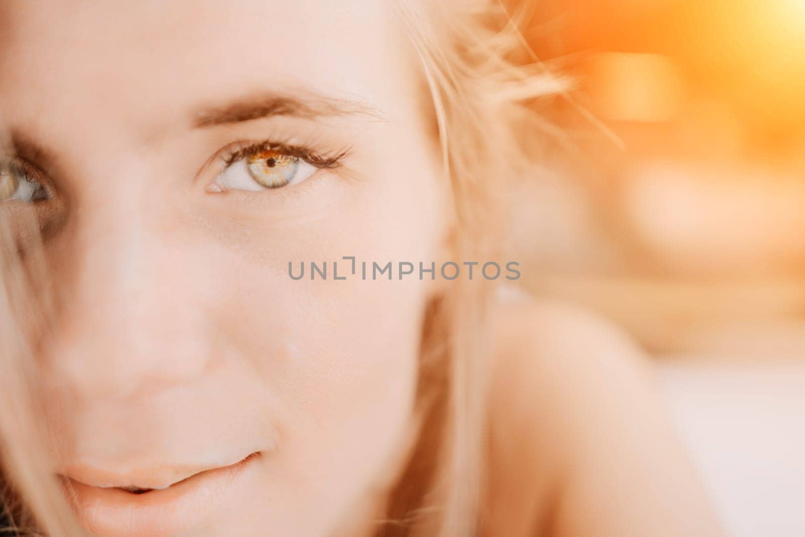 Happy woman portrait in cafe. Boho chic fashion style. Outdoor photo of young happy woman with long hair, sunny weather outdoors sitting in modern cafe. by panophotograph