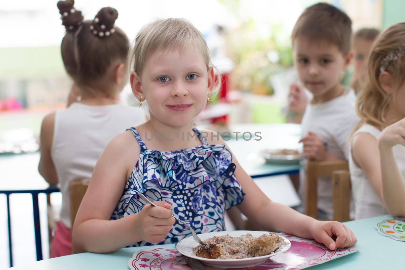 Belarus, Gomel, May 29, 2018. The kindergarten is central. Open Day.The child eats in a kindergarten. by Sviatlana